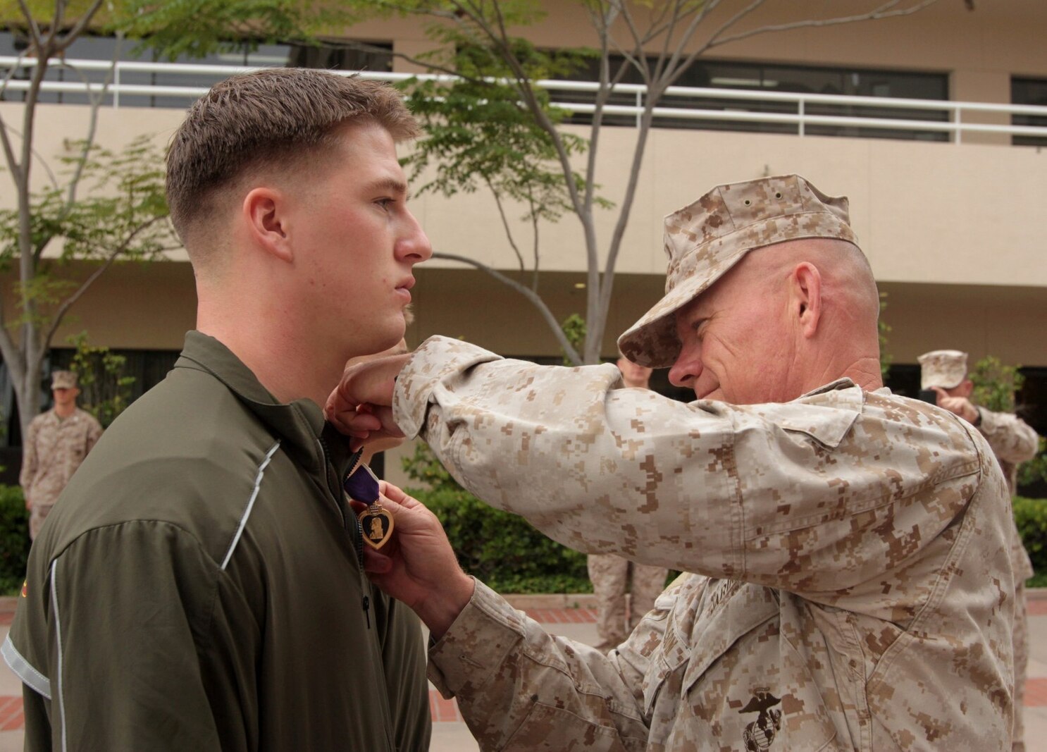 NAVAL MEDICAL CENTER SAN DIEGO, Calif. – Major Gen. Lawrence D. Nicholson, 1st Marine Division commanding general, presents the Purple Heart to Cpl. Matthew S. Babler, a rifleman temporarily assigned to Wounded Warrior Battalion West, during an award ceremony here, July 31, 2013. Babler, a native of Monticello, Wisc., was wounded by enemy sniper fire, July 2, 2013, while deployed with 3rd Battalion, 4th Marine Regiment, to Musa Qal’ah district, Helmand province, Afghanistan, in support of Operation Enduring Freedom. Babler is a 2009 graduate of Monticello High School. 
(U.S. Marine Corps photo by Sgt. Jacob H. Harrer)