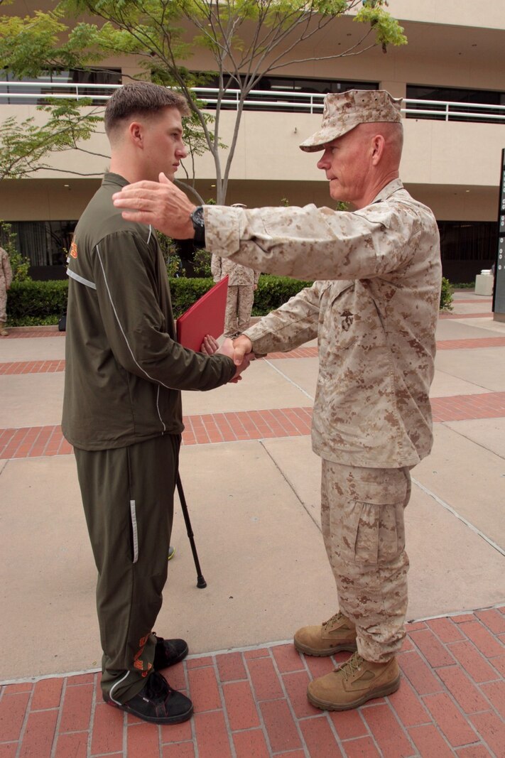 NAVAL MEDICAL CENTER SAN DIEGO, Calif. – Major Gen. Lawrence D. Nicholson, 1st Marine Division commanding general, congratulates Cpl. Matthew S. Babler, a rifleman temporarily assigned to Wounded Warrior Battalion West, after presenting the Purple Heart during an award ceremony here, July 31, 2013. Babler, a native of Monticello, Wisc., was wounded by enemy sniper fire, July 2, 2013, while deployed with 3rd Battalion, 4th Marine Regiment, to Musa Qal’ah district, Helmand province, Afghanistan, in support of Operation Enduring Freedom. Babler is a 2009 graduate of Monticello High School. 
(U.S. Marine Corps photo by Sgt. Jacob H. Harrer)