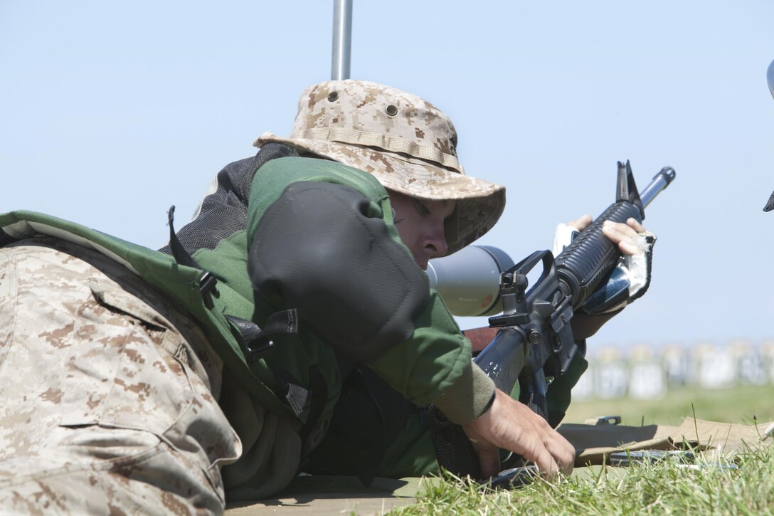 Lance Cpl. Shane O’Flynn, a member of the Marine Forces Reserve Marksmanship Training Unit, Marine Corps Reserve Rifle Team, based out of Marine Corps Base Quantico, Va., reloads his rifle on the 300-yard line during the National Trophy Individual Match at Camp Perry, Ohio, July 30. The rifle match is part of the annual Civilian Marksmanship Program's National Matches, which have been taking place annually since 1903. (U.S. Marine Corps photo by Cpl. Jessica Ito)