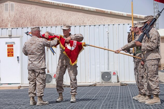 Col. A. E. "Sparky" Renforth, Regimental Combat Team 7 commanding officer, and Sgt. Maj. Scott Samuels, RCT-7 sergeant major, furl the RCT-7 flag during a casing of the colors ceremony here, July 31, 2013.  "We've thought the whole time about the legacy that came before us and not wanting to let down those Marines," Renforth said. "We're proud to have been the last regiment." (Marine Corps photo by Cpl. Lia Adkins)