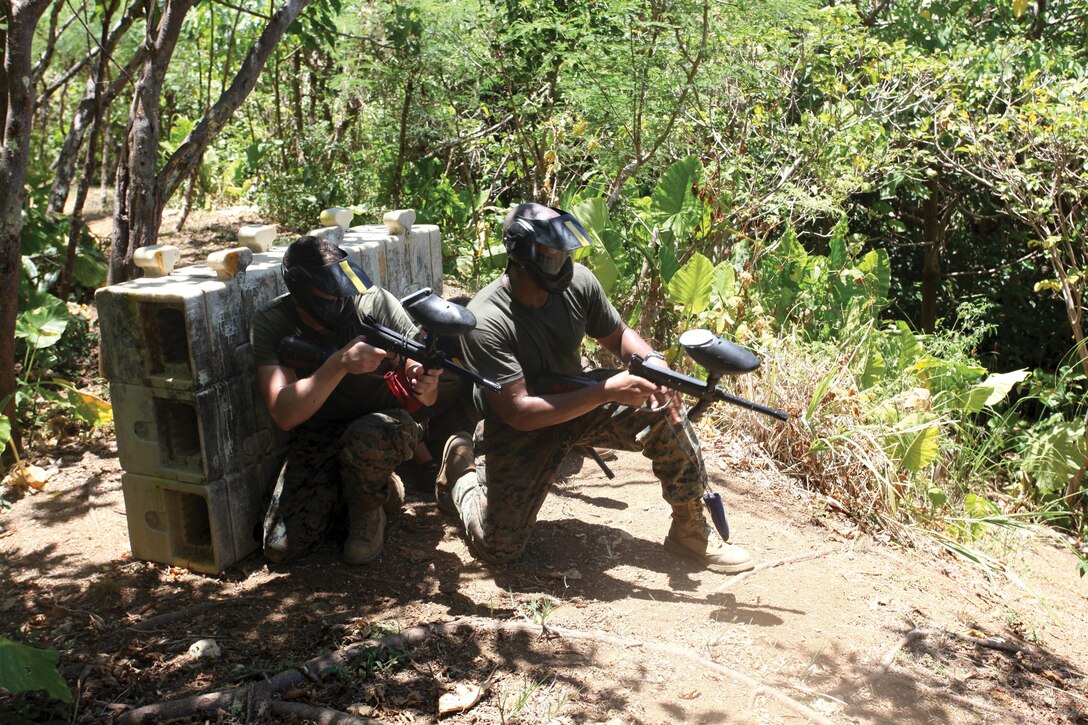 Marines react to an ambush during a paintball match July 26 at the Xsplat paintball field near White Beach Port Facility. The Marines are with 5th Air Naval Gunfire Liaison Company, III Marine Expeditionary Force Headquarters Group, III MEF. Photo by Sgt. Brian A. Marion