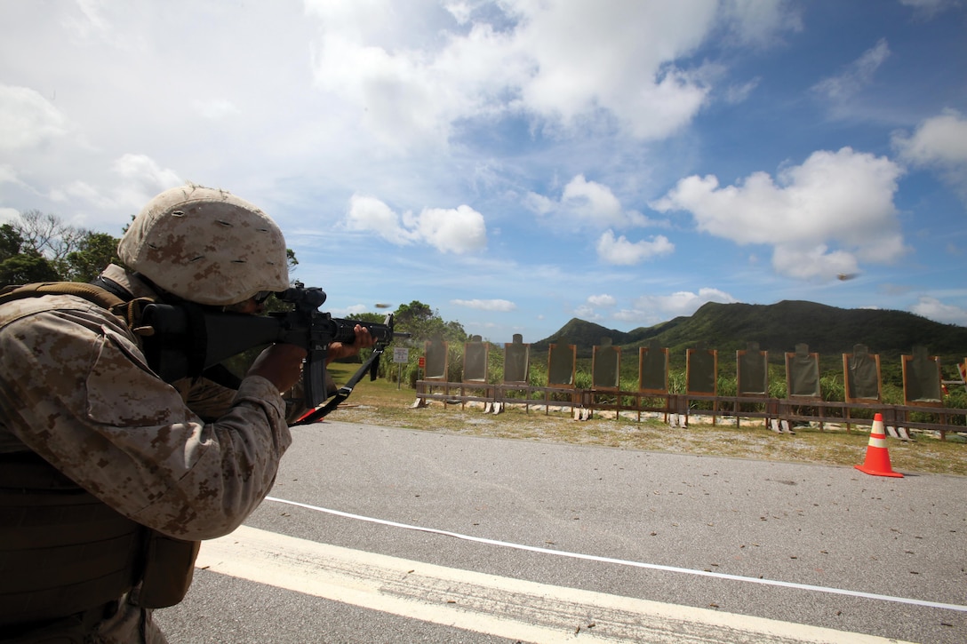 Lance Cpl. Sean M. Clark shoots while advancing during an intermediate combat rifle marksmanship course July 24 at Range 8 on Camp Hansen. “The course applies the basics of rifle marksmanship and combat rifle marksmanship and adds extra movements to each course of fire (to include) pivots and forward advances,” said Cpl. Robert J. Smith II. Clark and Smith are military policemen assigned to Company B, 3rd Law Enforcement Battalion, III Marine Expeditionary Force Headquarters Group, III MEF. Photo by Lance Cpl. Henry J. Antenor