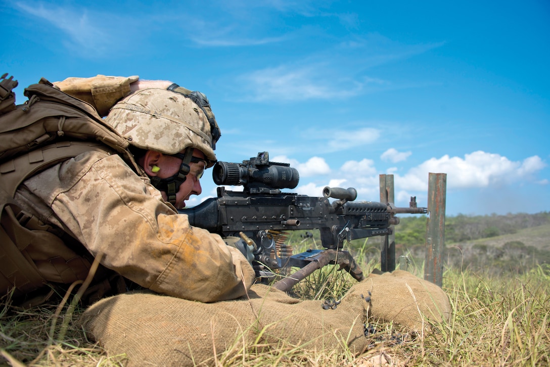 Pfc. Nathaniel A. Henthorne engages and suppresses targets July 22 at Range 10 near Camp Schwab during a combined-arms exercise. Marines with Combat Engineer Co., CAB, worked with mortarmen with 3rd Battalion, 6th Marine Regiment, to suppress targets with medium and light machine gun fire along with 60 mm mortars, allowing a squad of combat engineers to maneuver to and reduce obstacles. The engineers used bangalore torpedoes to clear a path through the danger area before confirming the passageway was clear and marked the lane for follow-on forces. Henthorne is a combat engineer with Combat Engineer Co., CAB, 3rd Marine Division, III MEF. 3rd Bn., 6th Marines, is assigned to 4th Marines, 3rd Marine Division, III MEF, under the unit deployment program. Photo by Cpl. Mark W. Stroud