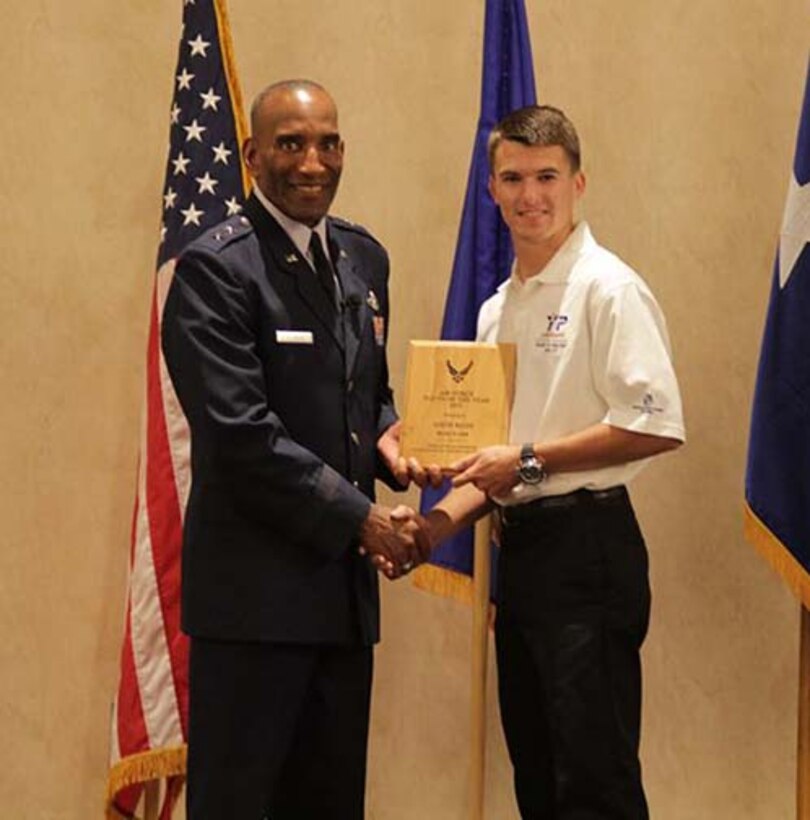 Seventeen-year-old Austin McCoy accepts his award for Air Force Reserve Command's Youth of the Year 2013 from Maj. Gen. Alfred J. Stewart, commander, Air Force Personnel Center, Joint Base San Antonio-Randolph, Texas. Austin received the award for his extensive volunteer work, philanthropic aspirations and involvement in activities as an Eagle Scout. (Courtesy photo)