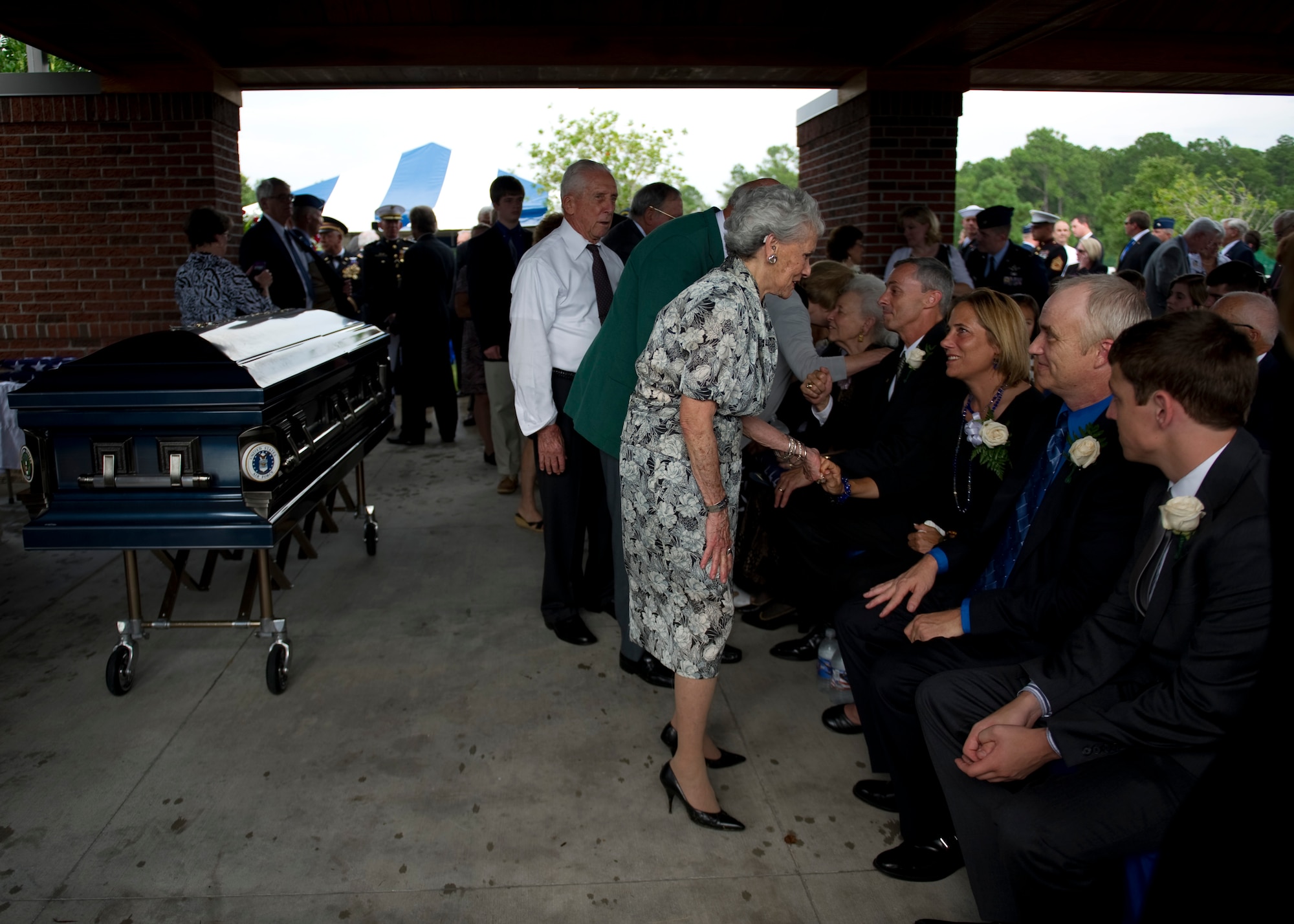Guest of retired U.S. Air Force Col. George “Bud” Day’s funeral pay their final respects to Day’s family upon the conclusion of his funeral service at Barrancas National Cemetery on Naval Air Station Pensacola, Fla., Aug. 1, 2013. Day, a Medal of Honor recipient and combat pilot with service in World War II, Korea and Vietnam, passed away July 28 at the age of 88. (U.S. Air Force Photo/Staff Sgt. John Bainter)