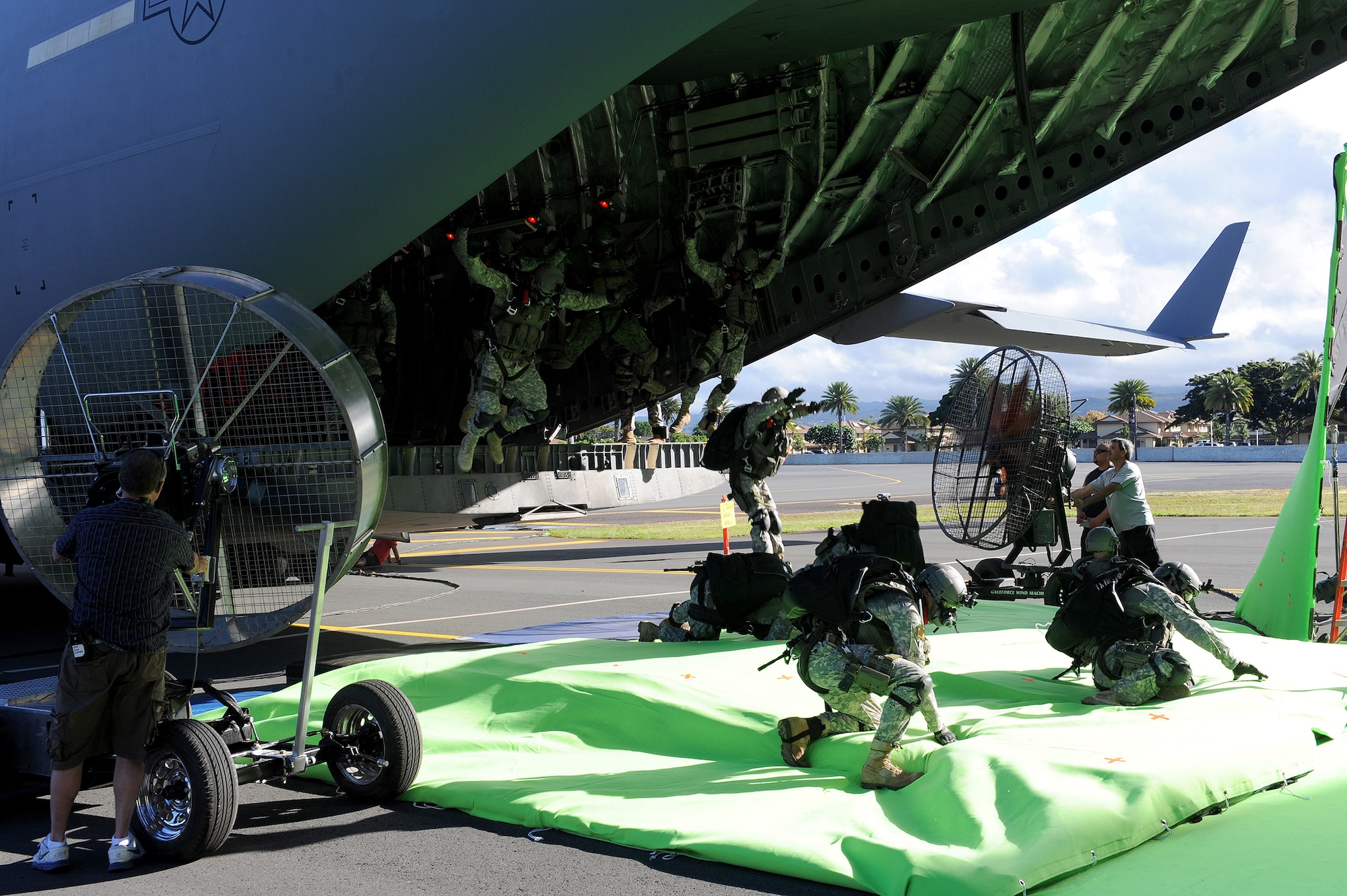 Movie extras jump from the ramp of a C-17 Globemaster III near Hangar 19, at Joint Base Pearl Harbor Hickam-Hawaii, July 1, 2013. The jump will be used in a scene for a major motion picture which is scheduled to premiere in 2014. (U.S. Air Force photo/Tech. Sgt. Jerome S. Tayborn)