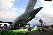 Production crew members set up a scene aboard a 535th Airlift Squadron C-17 Globemaster III during the filming of a major motion picture film at Hangar 19, Joint Base Pearl Harbor-Hickam, Hawaii, July 1, 2014.  (U.S. Air Force photo/Tech. Sgt. Jerome S. Tayborn)