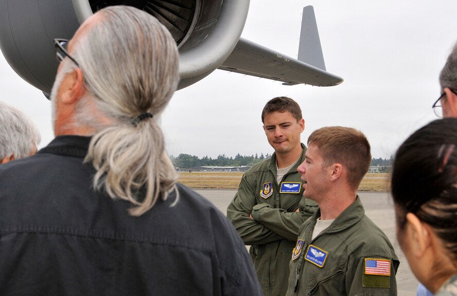 Tech. Sgt. Chris Kelley and Senior Airman Mitchell Williams, 97th Airlift Squadron loadmasters, out McChord Field, Wash., describe the capabilities of the C-17 Globemaster III aircraft to a group of community leaders outside of a C-17 on the McChord Field flightline, July 31, 2013. The C-17 static display was one of many stops for the group’s orientation tour at McChord, hosted by Western Air Defense Sector leadership. (U.S. Air Force Reserve photo/Master Sgt. Jake Chappelle)