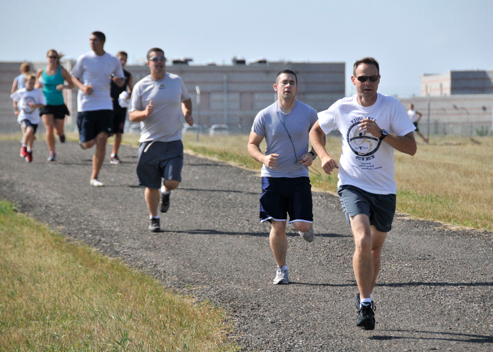Master Sgt. Brian Bickel, 120th Fighter Wing of the Montana Air National Guard, leads a group of runners during the annual MTANG Family Day fun run on Aug. 11, 2012. This year’s family day is scheduled for Aug. 11. (U.S. Air Force photo/John Turner)

