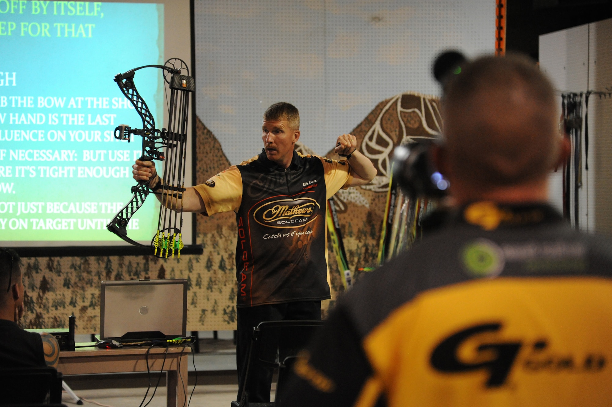Kirk Clark, 341st Medical Operations Squadron exercise physiologist, demonstrates proper technique when using a bow and arrow during a class at Outdoor Recreation on July 23.  Clark hosts seminars throughout the year in hopes of helping people with varying degrees of hunting knowledge hone their skills in bow hunting. (U.S. Air Force photo/Airman 1st Class Collin Schmidt)