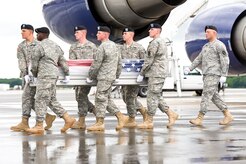 A U.S. Army carry team transfers the remains of Army Spc. Nicholas B. Burley of Red Bluff, Calif., Aug. 1, 2013 at Dover Air Force Base, Del. Burley was assigned to the 6th Squadron, 8th Cavalry Regiment, 4th Infantry Brigade Combat Team, 3rd Infantry Division, Fort Stewart, Ga. (U.S. Air Force photo/Roland Balik)
