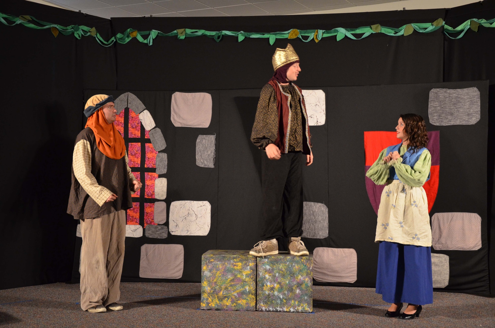 Joshua Tatton (center) recites his lines as 'King Backwards,' as his stage daughter, 'Snow White,' played by Pearl Suarez (right) listens intently.  Jake Stempel (left), a tour actor/director with Missoula Children's Theater, came to Patrick AFB, Fla., July 22-26 to bring performing arts to the children of Patrick's Youth Center.  Stempel and his traveling partner, Kelly Combs, spent the week directing 55 'junior actors' in the performance of "Snow White and the Seven Dwarfs."  (U.S. Air Force photo by Susan A. Romano)
