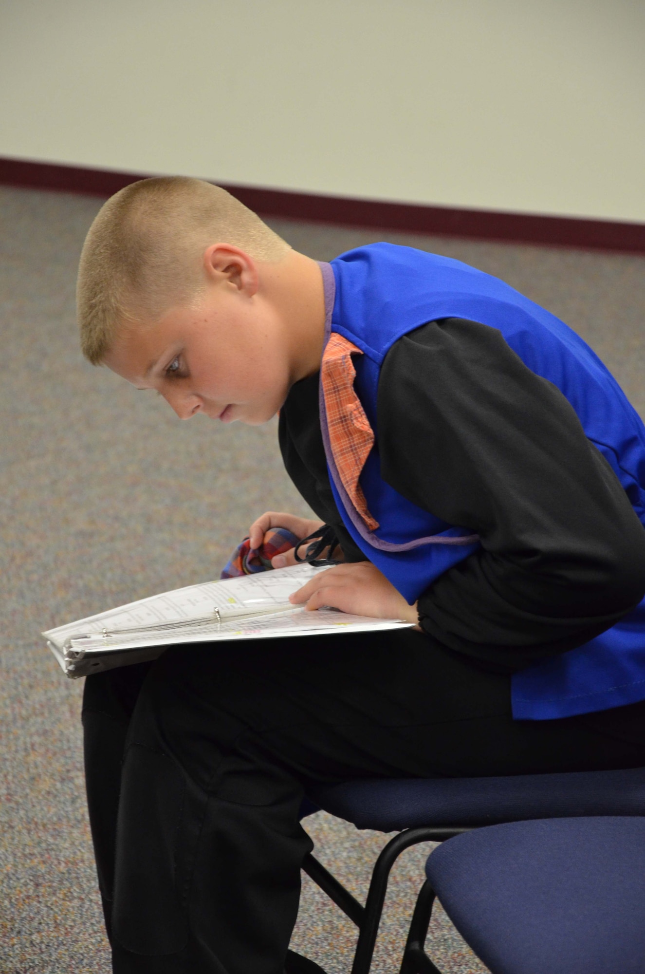 Hunter Plotkin, a member of Patrick AFB's Youth Center, studies his lines prior to the dress rehearsal of "Snow White and the Seven Dwarfs" July 26, 2013.  Plotkin, along with 55 other Air Force children, were part of the Missoula Children's Theater, a traveling theater company that spends a week at a time at locations throughout the United States bringing theater arts to local communities.  (U.S. Air Force photo by Susan A. Romano)
