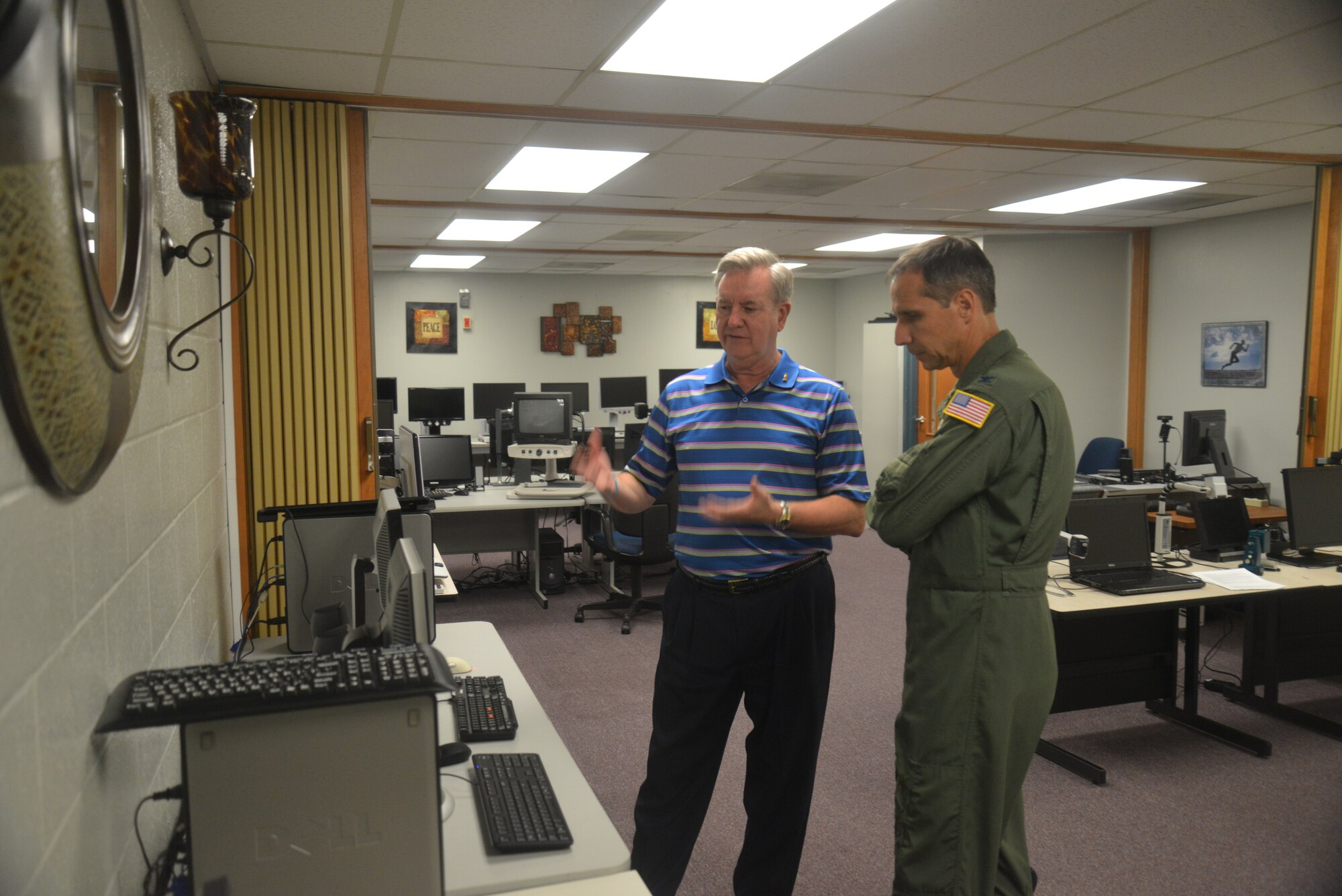 Mike Gilliam, president and CEO of the San Antonio Lighthouse for the Blind, left, in the vocational  training section describes to Col. Jeffrey Pennington, 433rd Airlift Wing commander, Joint Base San Antonio – Lackland, the independent living rehabilitation program that the Lighthouse provides to individuals who are blind or visually impaired, as well as those with other disabilities. (U.S. Air Force photo by Senior Master Sgt. Minnie Jones)

