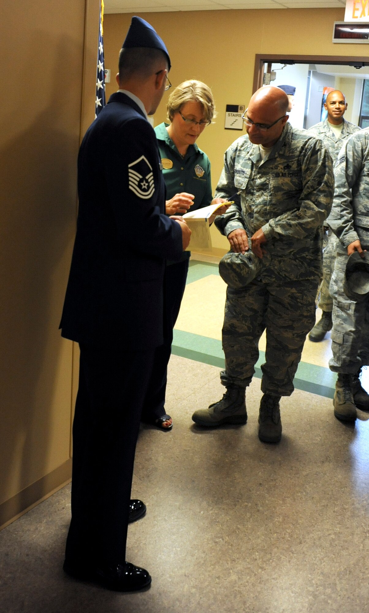 Heidi Malkowski, Joint Base McGuire-Dix-Lakehurst Protocol officer, discusses protocol plans with Col. Anthony Esposito, 514th Maintenance Group commander, before the 87th Air Base Wing change of command July 25, 2013, at Hangar 3307, JB MDL, N.J. The protocol office arranges ceremonies to ensure participants conform to standards and adhere to traditions. (U.S. Air Force photo by Airman 1st Class Sean M. Crowe/Released)