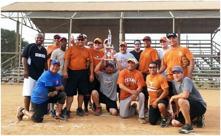 The members of the 149th Fighter Wing ‘Gunfighters’ celebrate their victory in the JBSA-Lackland intramural softball championship. (Courtesy Photo)