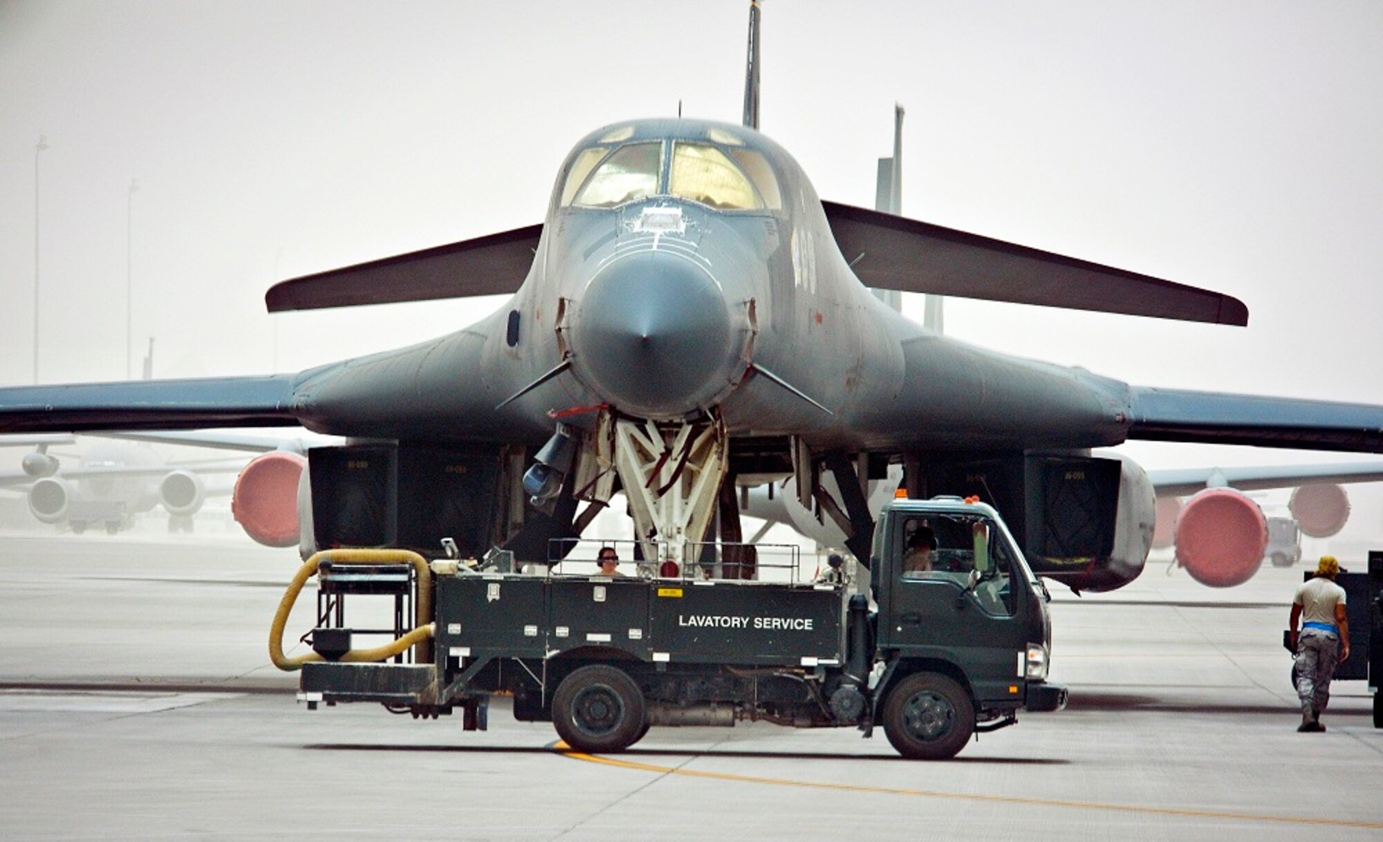 Airmen from the 8th Expeditionary Air Mobility Squadron fleet services remove waste from a 34th Expeditionary Bomb Squadron B-1B Lancer at the 379th Air Expeditionary Wing in Southwest Asia, June 11, 2013. Once an aircraft comes to the flightline, the lavatory service truck goes out to the aircraft and attaches a pipe to the plane with what they call the "moose head" for a nozzle. A handle is pulled releasing the waste which then flows through the pipe and into the truck. Not only do these Airmen care for Air Mobility Command aircraft, but are the only fleet services unit in the U.S. Central Command's area of responsibility taking care of any aircraft transiting through the 379th AEW. (U.S. Air Force photo by Senior Airman Benjamin Stratton/Released)