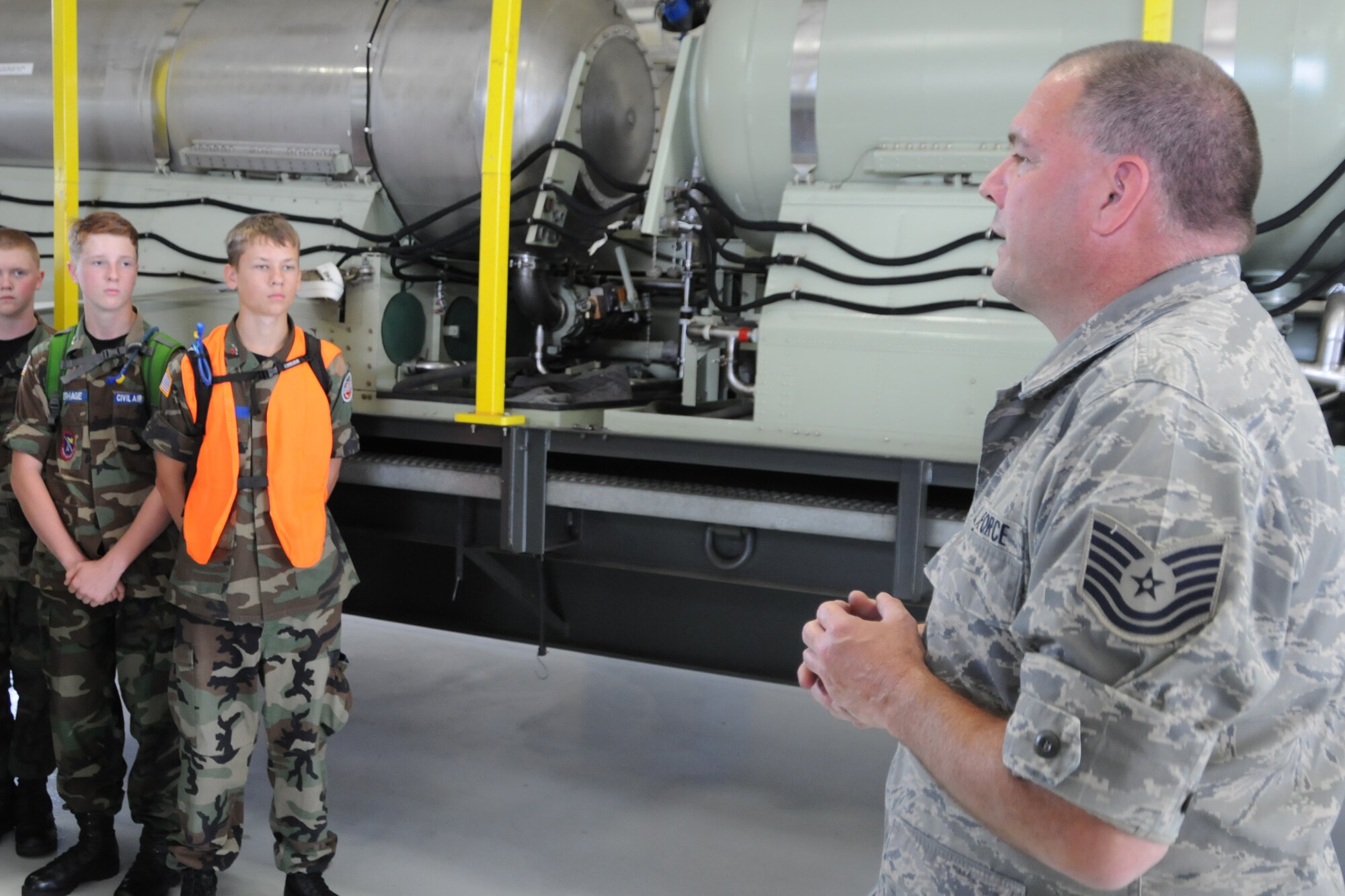 YOUNGSTOWN AIR RESERVE STATION, Ohio--Air Force ReserveTechnical Sgt. Mike Lamantia explains the C-130 Modular Aerial Spay System (MASS) to a group of Civil Air Patrol cadets here, July 31, 2013. The Civil Air Patrol toured the base on Wednesday, visiting the aerial spray shop as well as avionics, propulsion and the Navy and Marine Corps Reserve Center. Lamantia is a 910th Aerial Spray Maintenance Technician here. YARS is home to the Department of Defense’s only large-area fixed-wing aerial spray capability. (U.S. Air Force photo by Technical Sergeant James Brock) 