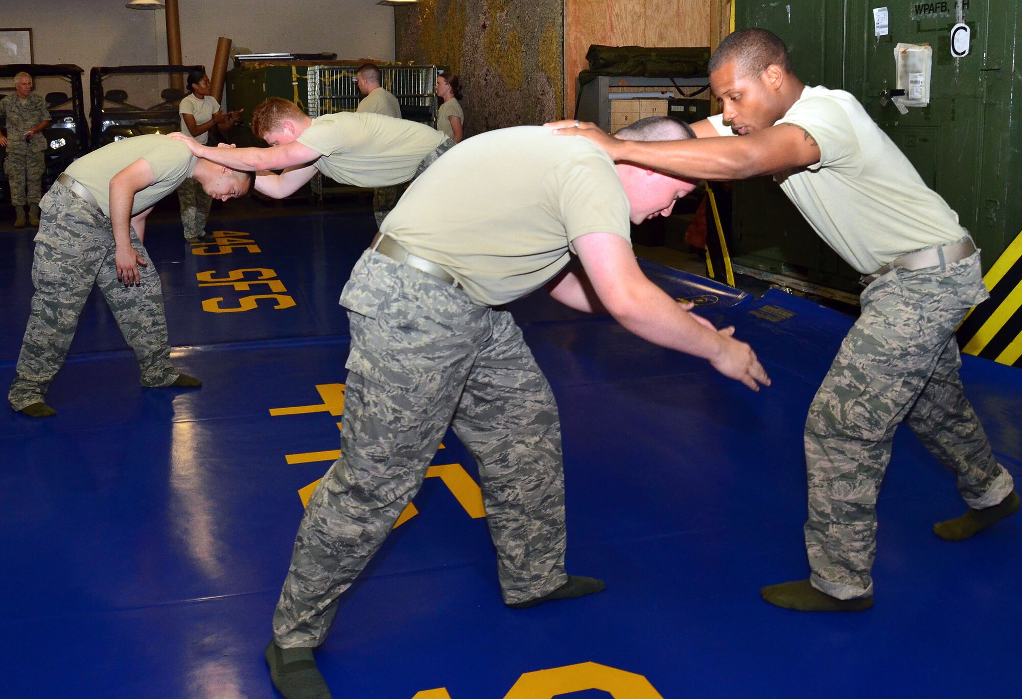 WRIGHT-PATTERSON AIR FORCE BASE, Ohio - Staff Sgt. Michael O’Callaghan, 445th Security Forces Squadron journeyman, teaches new combative techniques while using Senior Airman Shayne Denihan, 445 SFS helper, as a model during the July 13 unit training assembly. All security forces members are required to participate in the training. This training is specifically for SFS and is different from Army and Air Force combative training. (U.S. Air Force photo/Staff Sgt. Amanda Duncan)