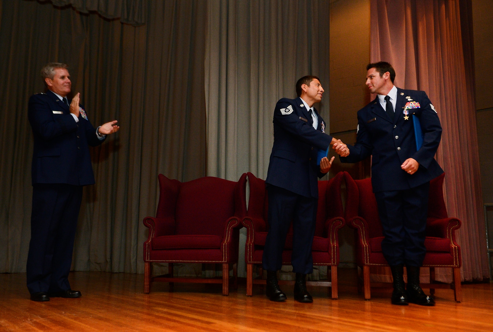 Lt. Gen. Eric E. Fiel, Commander, Air Force Special Operations Command, congratulates Tech. Sgt. Ismael Villegas, 24th Special Operations Wing combat control recruit liaison, and Staff Sgt. Dale Young, 342nd Training Squadron combat control instructor, after being awarded Silver Stars, July 22, 2013. Villegas and Young were awarded Silver Stars for their actions against enemy forces in Afghanistan. (U.S. Air Force photo by Staff Sgt. Vernon Young Jr.)