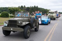 HANSCOM AIR FORCE BASE, Mass. – Airmen are recognized during a Heroes Homecoming parade down Barksdale Street July 25 as base personnel lined the streets to wave American flags and show their appreciation to recent deployers. The parade was followed by a picnic in Memorial Park that recognized deployers and their families for outstanding service and commitment. (U.S. Air Force photo by Rick Berry)