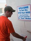 Airman 1st Class Trevor McKey, 47th Flying Training Wing Judge Advocate office advisor, paints part of the Veterans of Foreign Wars building in Del Rio, Texas, July 27, 2013. Laughlin members dedicated their Saturday to help give the building a new look. (U.S. Air Force Photo/Airman 1st Class Jimmie D. Pike)