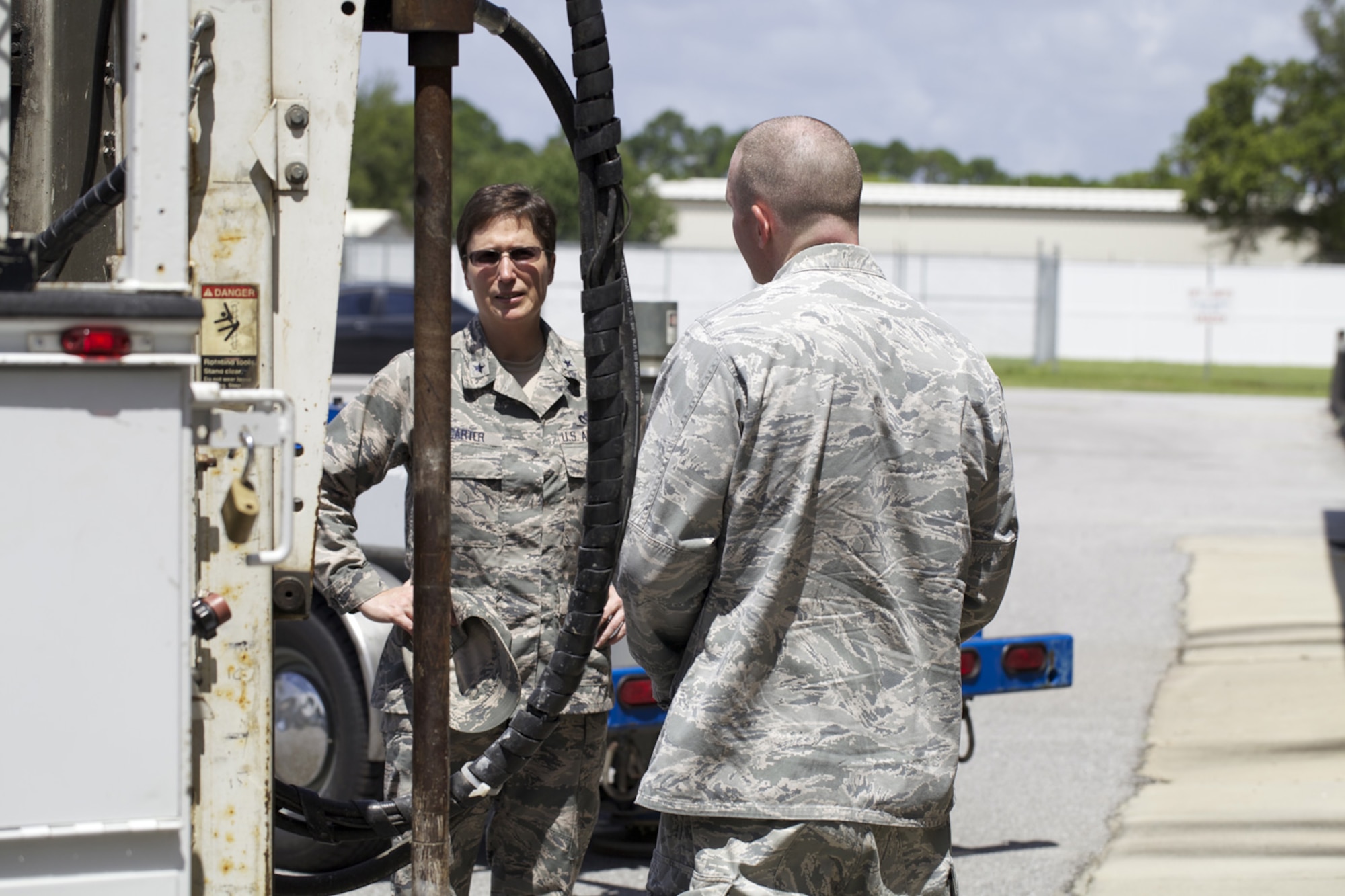 TYNDALL AIR FORCE BASE, Fla. -- Brig. Gen. Theresa Carter, the Air Force Civil Engineer, talks with Maj. Timothy Grady, Airfield Pavement Evaluation team chief, during a visit to Det. 1, Air Force Civil Engineer Center here July 31. In addition to developing guidance and providing technical support to Air Force installations, AFCEC’s APE division tests strength and friction characteristics at airfields around the world to assist the Air Force in sustaining flight capabilities. Carter’s trip to AFCEC marked the first since she was named the Civil Engineer in June. (U.S. Air Force photo/Eddie Green)
