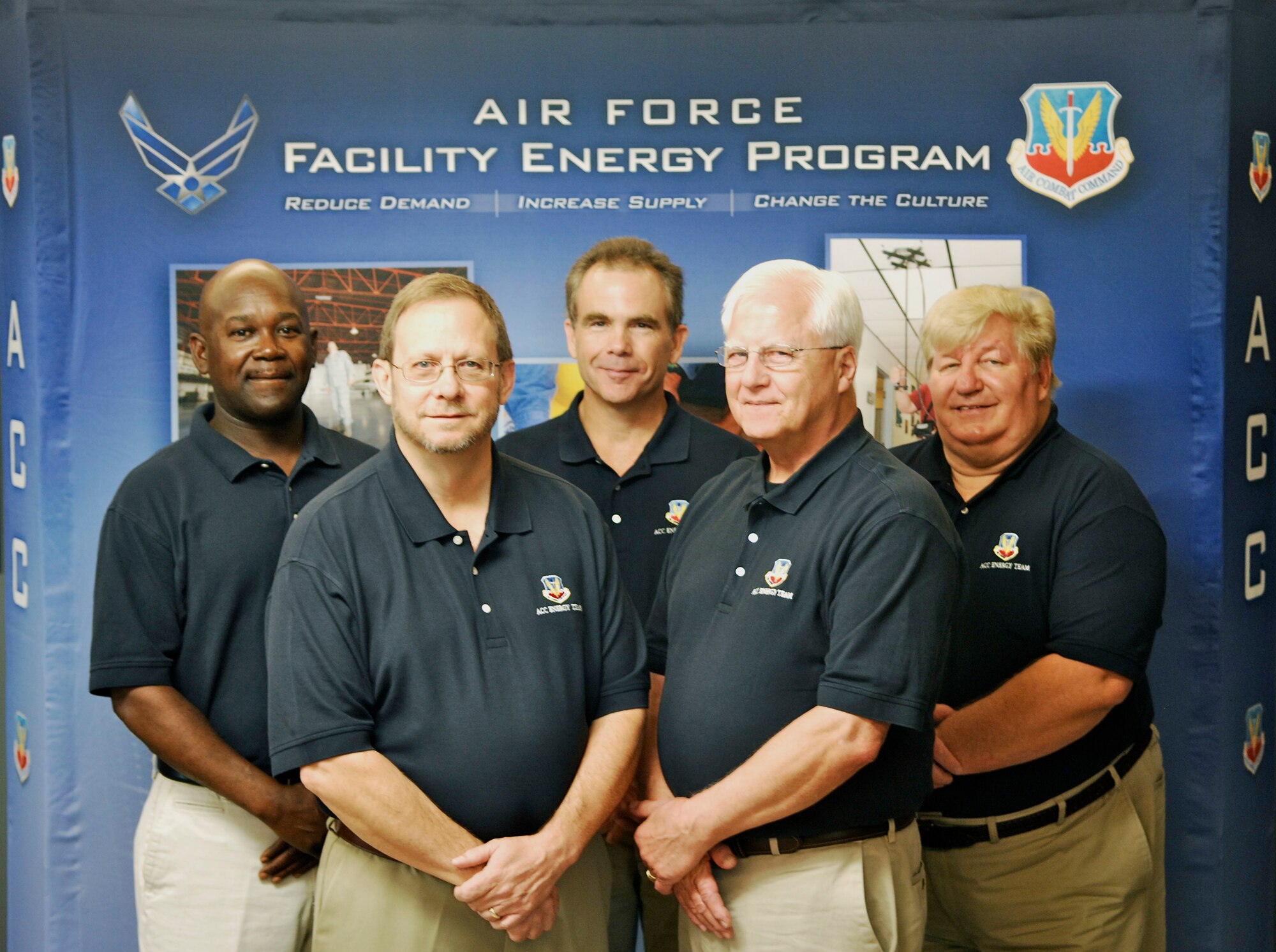 JOINT BASE LANGLEY-EUSTIS, Va. -- The Air Combat Command facility energy team expertly managed a comprehensive program for 16 installations earning them a 2013 Federal Energy Management Program Award. Among its many achievements, the team oversaw the award of 39 energy projects, which are expected to save 450,450 MBTUs and $5.5 million annually. Pictured from left: Resource Efficiency Manager John McDuffie, Energy Projects Manager Steven White, Energy Management Systems Manager William Turnbull, Program Analyst William Kuster and Energy Technical Advisor Dennis Svalstad.  (U.S. Air Force photo/Sachel Seabrook)