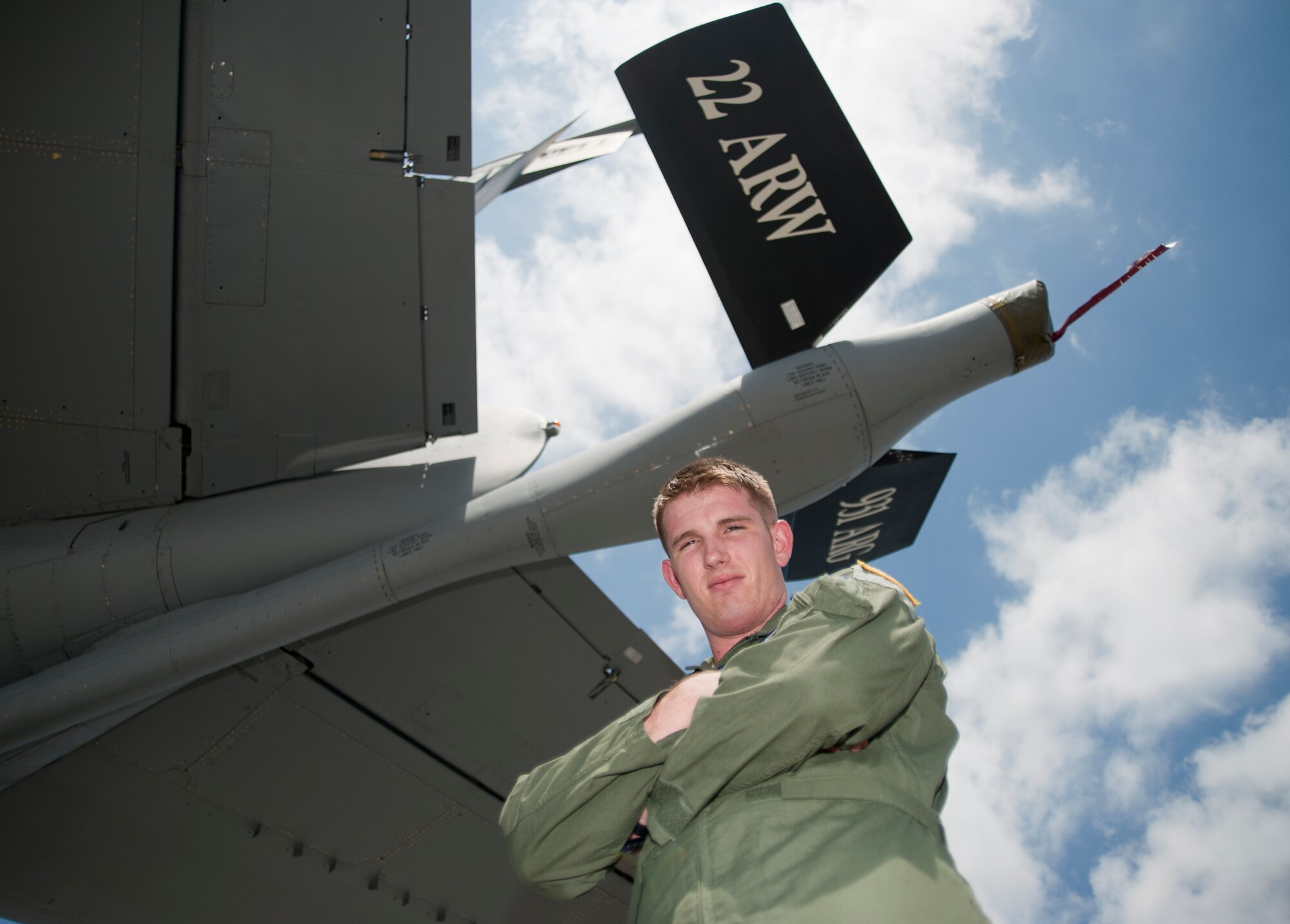 Airman 1st Class Alex Woosley, 344th Air Refueling Squadron boom operator, poses underneath the boom on a KC-135 Stratotanker July 31, 2013,  at McConnell Air Force Base, Kan. Woosley was selected to be the 22nd Air Refueling Wing spotlight performer for the week of July 29 to Aug. 2. (U.S. Air Force photo/Airman 1st Class Victor J. Caputo)