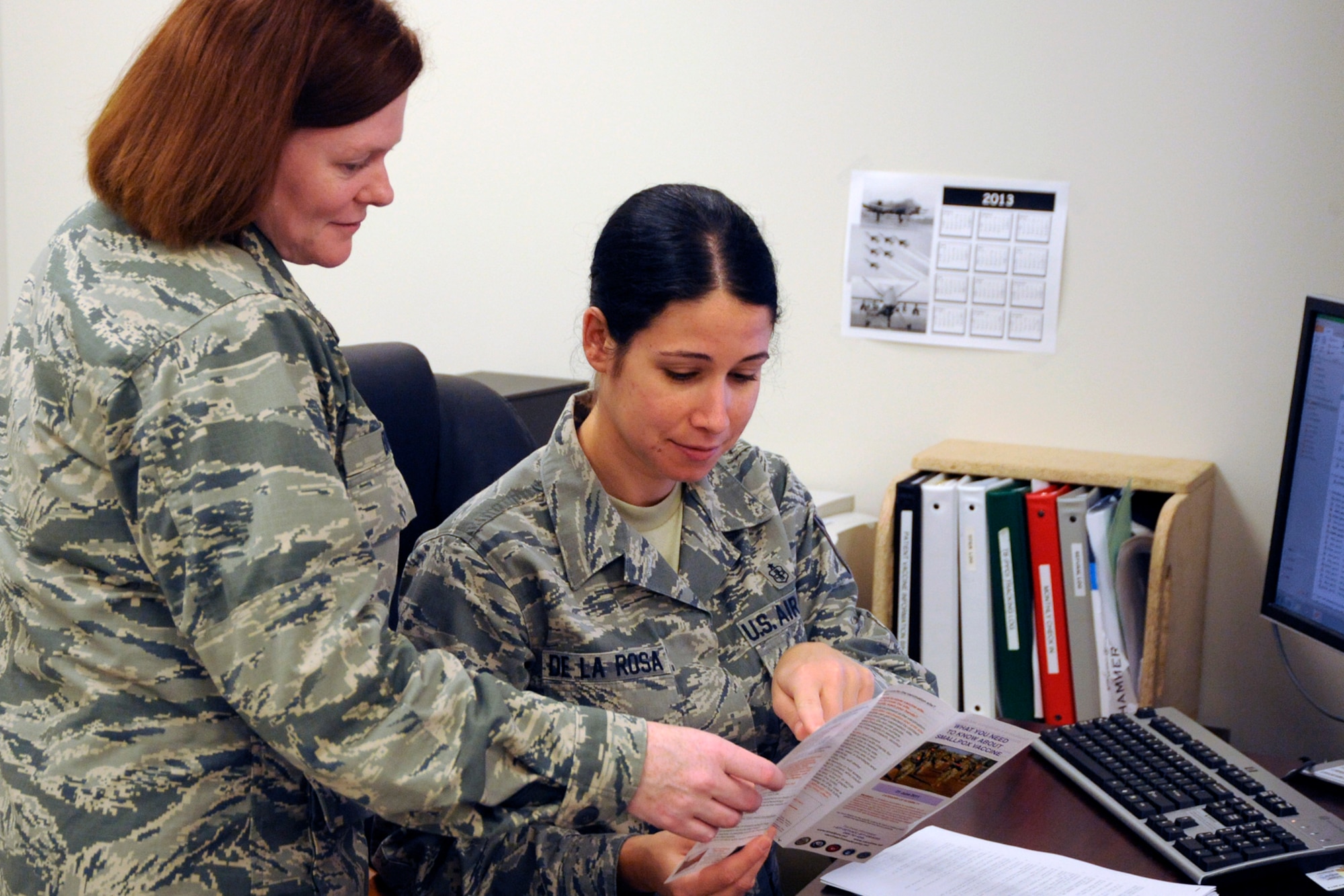 130725-Z-HC784-009 – Capt. Cheryl Bink and TSgt. Deeahna De La Rose, both members of the 127th Medical Group, review information on proper procedures to draw blood for medical testing purposes at Selfridge Air National Guard Base, July 25, 2013. The 127th Medical Group is charged with maintaining the medical readiness of nearly 1,700 Citizen-Airmen in the Michigan Air National Guard. (U.S. Air National Guard photo by John S. Swanson/Released)