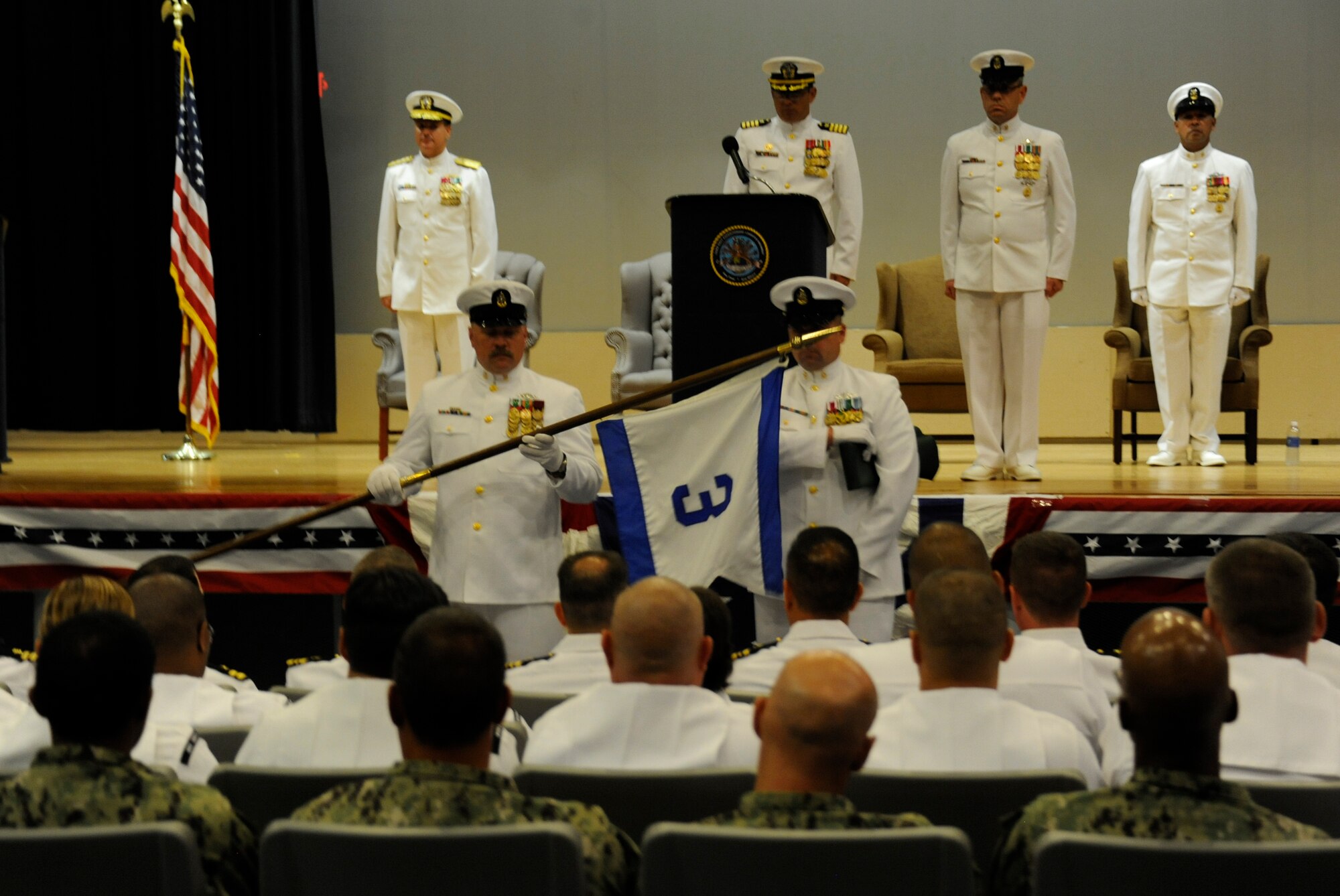 Sailors of the 3rd Navy Expeditionary Logistics Regiment case the unit’s pennant during the unit’s decommissioning ceremony July 27, 2013, at Joint Base McGuire-Dix-Lakehurst, N.J. Casing the pennant is a key part of a Navy decommissioning ceremony. The Sailors sent the pennant to their higher command after casing it. (U.S. Air Force photo by 1st Lt. Alexis McGee/Released)
