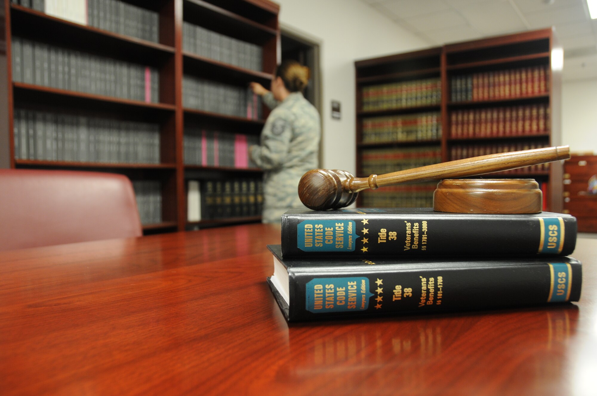 Master Sgt. Erika McFarlane, 131st Bomb Wing law office superintendent, reviews legal manuals July 20, 2013, at Whiteman Air Force Base, Mo. McFarlane and Lt. Col. Jason Klumb, 131st BW staff judge advocate, encourage every Airman to contact the legal office for help in drafting wills or powers of attorney documents. (U.S. Air National Guard photo by Airman 1st Class Nathan Dampf/Released)