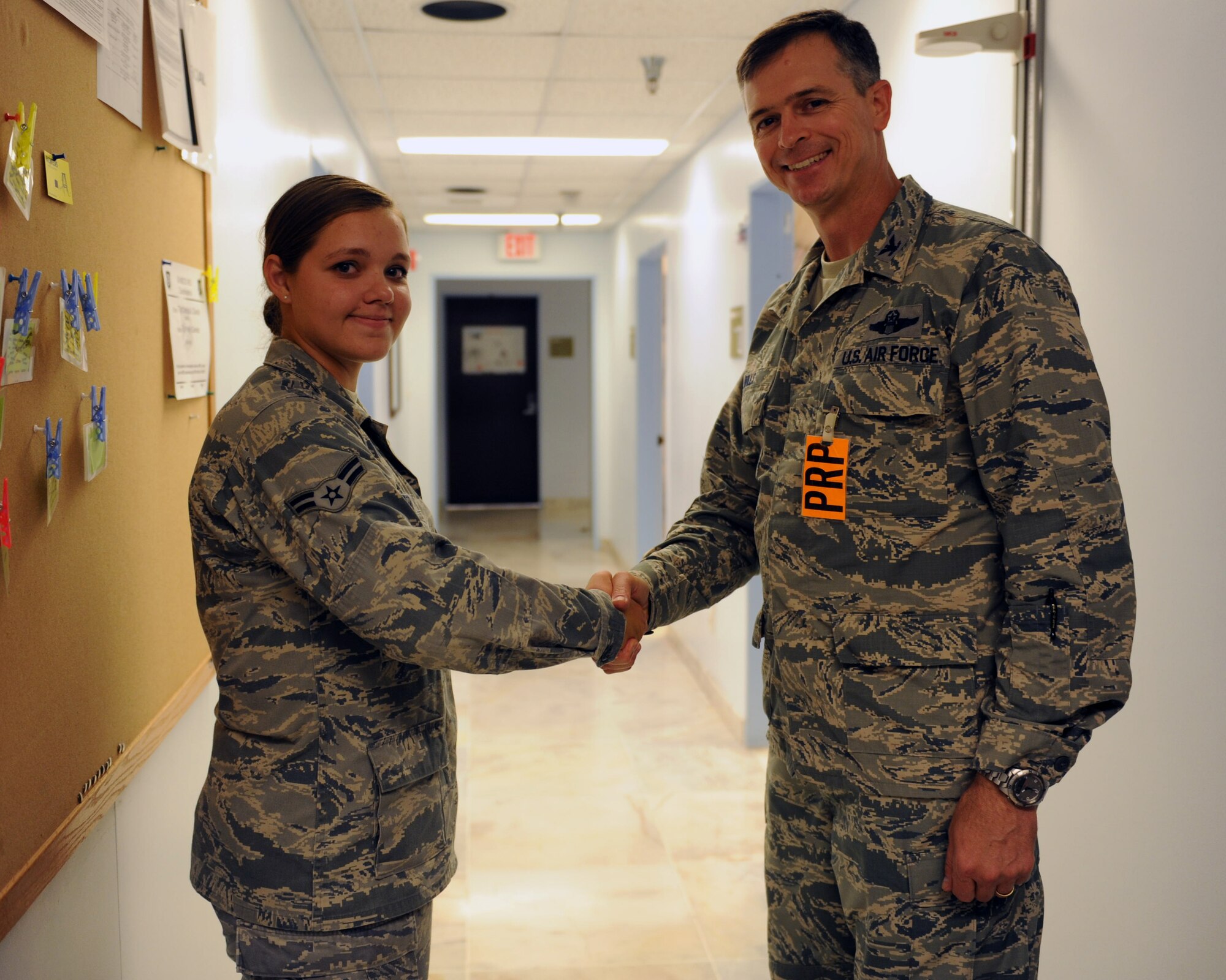 Airman 1st Class Samantha Kiper, 39th Medical Operations Squadron, is coined by Col. Craig Wills, 39th Air Base Wing commander, July 25, 2013, at Incirlik Air Base, Turkey. 