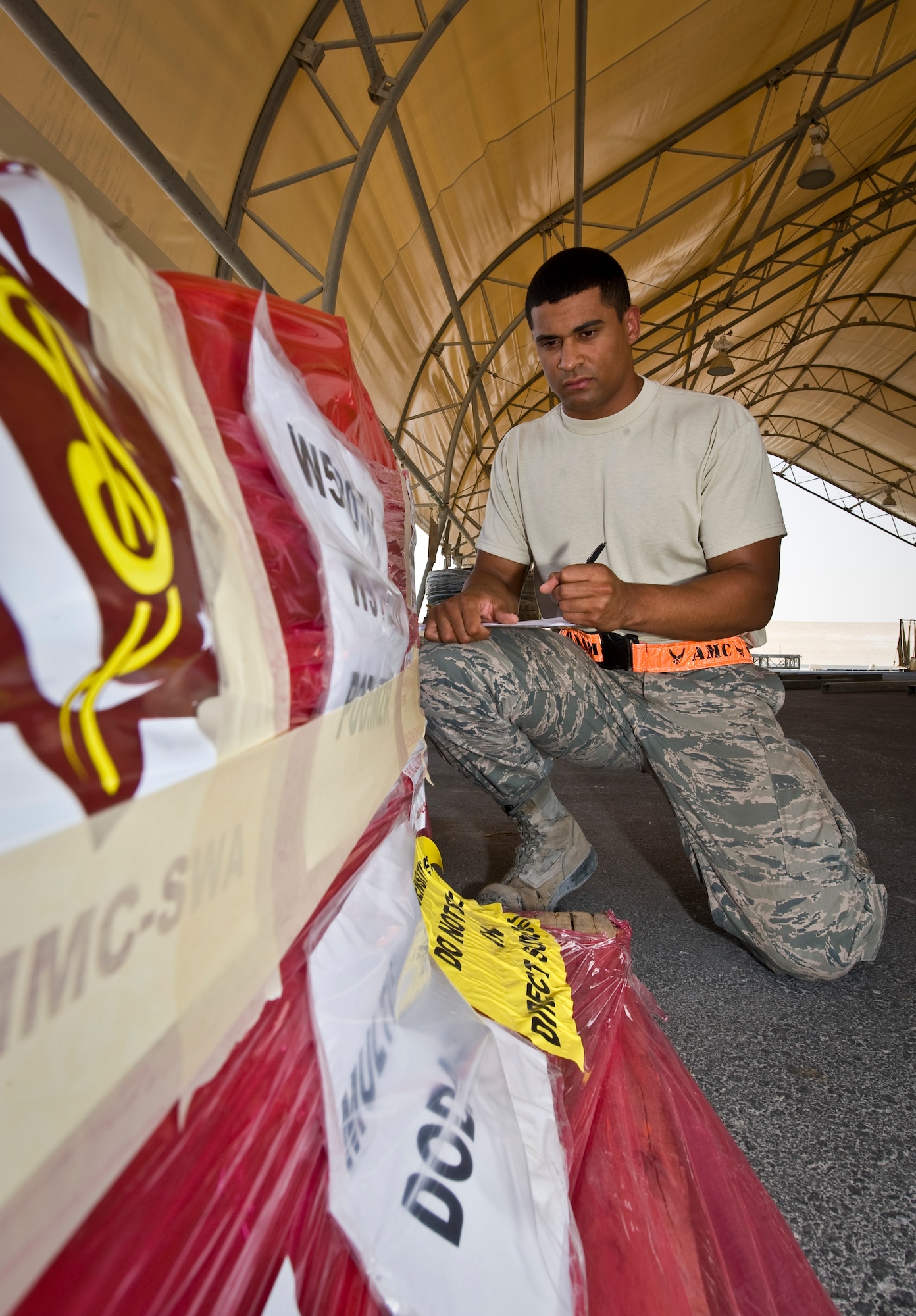 Airman 1st Class Gavin Marsh inspects specially labeled cargo at the 379th Air Expeditionary Wing in Southwest Asia, July 22, 2013. Marsh is an 8th Expeditionary Air Mobility Squadron cargo processing specialist deployed from Joint Base McGuire-Dix-Lakehurst, N.J. (U.S. Air Force photo/Senior Airman Benjamin Stratton)