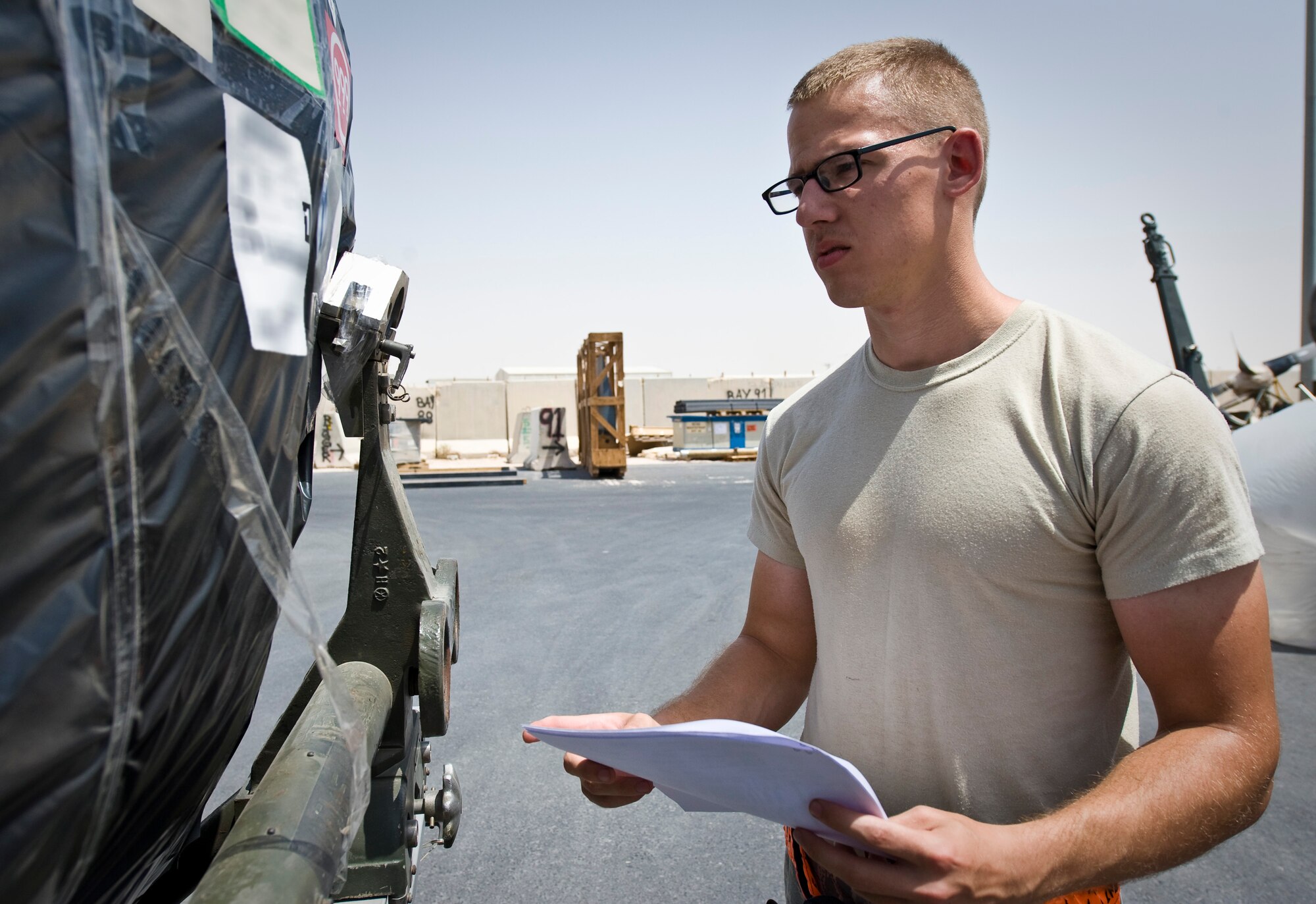 Senior Airman Sean Bryant inspects cargo and its paperwork at the 379th Air Expeditionary Wing in Southwest Asia, July 22, 2013. Bryant is an 8th Expeditionary Air Mobility Squadron special handling technician deployed from Joint Base McGuire-Dix-Lakehurst, N.J. (U.S. Air Force photo/Senior Airman Benjamin Stratton)