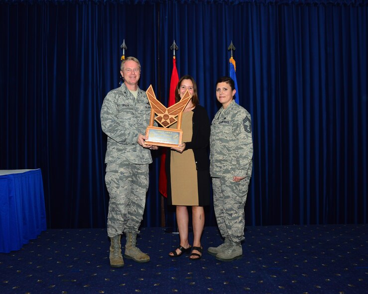 Jennifer Fletcher, 39th Air Base Wing director of staff, accepts the Chief's Spirit Award from Col. Brent Bigger, 39th Air Base Wing vice commander, on behalf of the 39th ABW during the promotion and awards ceremony July 31, 2013, at Incirlik Air Base, Turkey. The award is presented to the squadron that displays the most espirit de corps during the ceremony. (U.S. Air Force photo by Staff Sgt. Eric Summers Jr./Released)