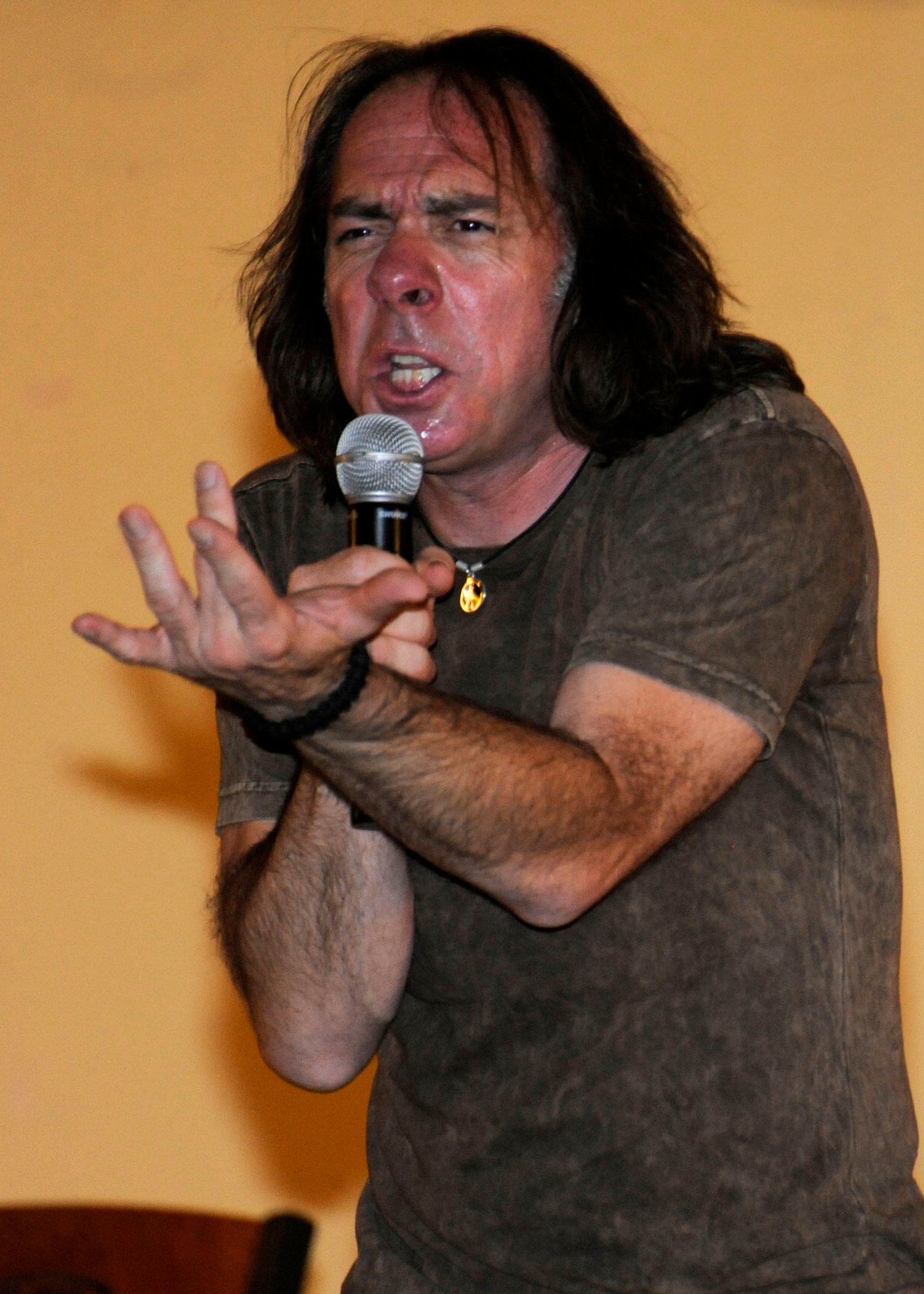 Comedian Jeff Capri animatedly tells a joke during Don Barnhart’s All-Star Comedy tour performance presented by Armed Forces Entertainment at the 379th Air Expeditionary Wing in Southwest Asia, July 28, 2013. Capri is one of four comedians in the comedy tour and has worked alongside several prominent entertainers to include Tim Allen, Ellen DeGeneres and Adam Sandler. (U.S. Air Force photo/Senior Airman Bahja J. Jones) 