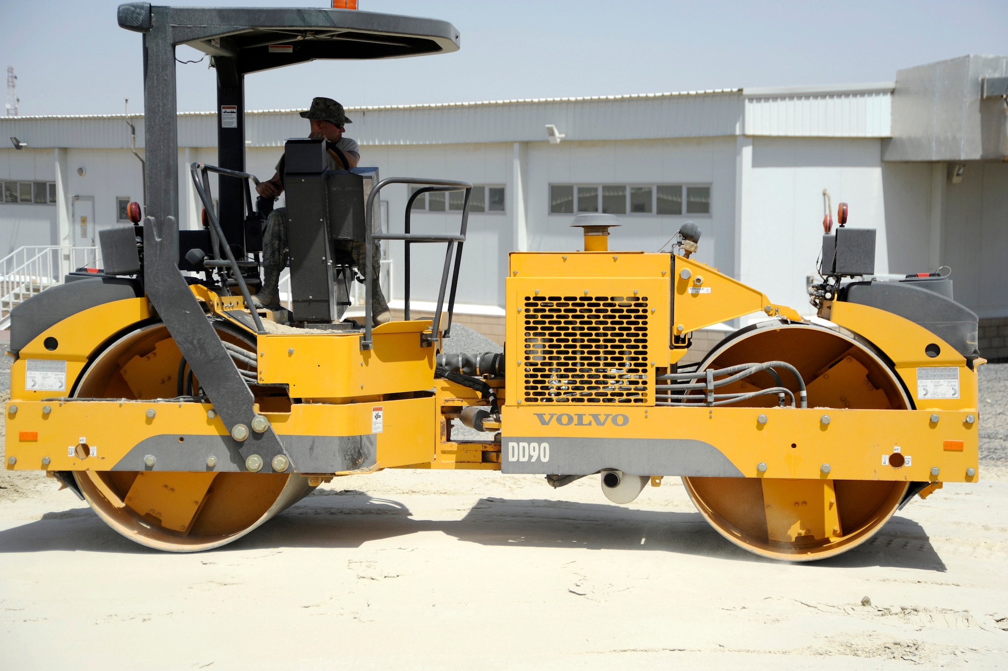 Tech. Sgt. Mark Ondersma, 386th Expeditionary Civil Engineer Squadron, heavy equipment operator, operates a Volvo vibratory roller here, July 24, 2013. Ondersma compacts the gatch to level it in preparation for a building at that location. Gatch is a sand and gypsum mix used under all buildings here; it is the equivalent to quick concrete. Ondersma, a native of Hudsonville, Mich. is deployed out of the 110th Airlift Wing, Battle Creek, Mich., Air National Guard unit. (U.S. Air Force photo by Master Sgt. Christopher A. Campbell)