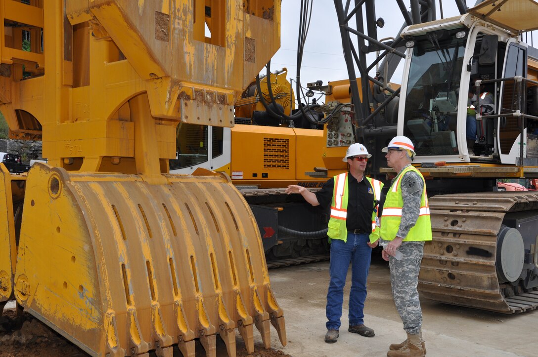 Bjoern Hoffman, left, Bauer Foundation Corporation project manager describes the Hydraulic Grab to Maj. Gen. Michael Walsh, right, deputy commanding general, Civil and Emergency Operations, U.S. Army Corps of Engineers during his July 31, 2013 visit to Nashville District’s Center Hill Dam. The Hydraulic Grab is used to pre-excavate embankment clay for the encasement wall in the ongoing Center Hill Dam Seepage Rehabilitation project. USACE photo by Fred Tucker)