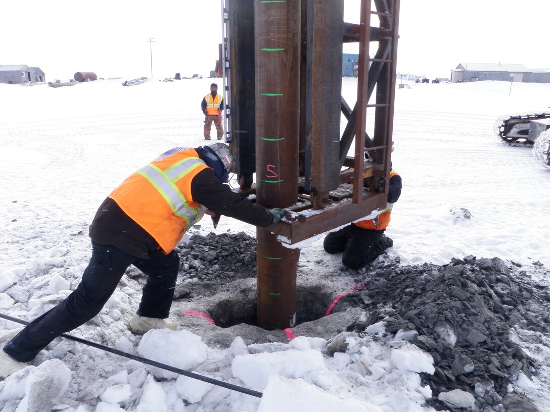 A contractor helps install a mooring point in rural Alaska. To date, the Corps has completed nine of 26 mooring point installations in places such as Chevak, Kwigillingak and Tuntutuliak. The average cost per mooring point is $21,097.