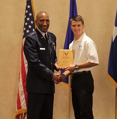 Seventeen-year-old Austin McCoy accepts his award for Air Force Reserve Command's Youth of the Year 2013 from Maj. Gen. Alfred J. Stewart, commander, Air Force Personnel Center, Joint Base San Antonio-Randolph, Texas. Austin received the award for his extensive volunteer work, philanthropic aspirations and involvement in activities as an Eagle Scout. (Courtesy photo)