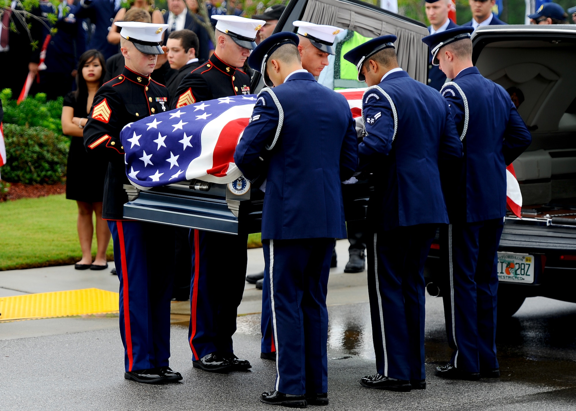Pallbearers, made up of Airmen and Marines, lift the casket of retired U.S. Air Force Col. George “Bud” Day from his hearse during the funeral service at Barrancas National Cemetery on Naval Air Station Pensacola, Fla., Aug. 1, 2013. Day, a Medal of Honor recipient and combat pilot with service in World War II, Korea and Vietnam, passed away July 28 at the age of 88. (U.S. Air Force Photo/ Airman 1st Class Jeffrey Parkinson)