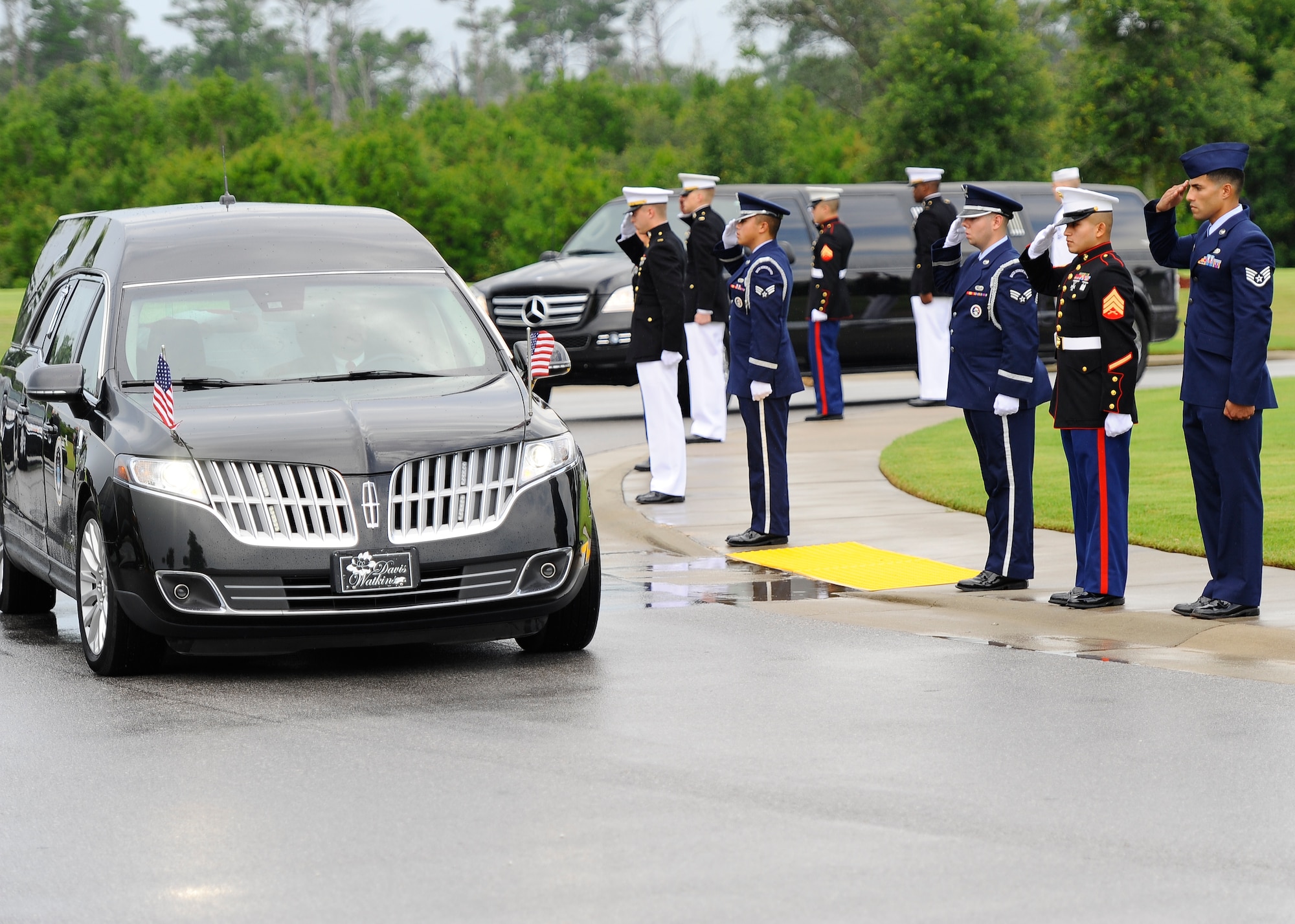 U.S. service members salute retired U.S. Air Force Col. George “Bud” Day’s hearse as it arrives to Barrancas National Cemetery on Naval Air Station Pensacola, Fla., Aug. 1, 2013. Day, a Medal of Honor recipient and combat pilot with service in World War II, Korea and Vietnam, passed away July 28 at the age of 88. (U.S. Air Force Photo/ Airman 1st Class Jeffrey Parkinson)