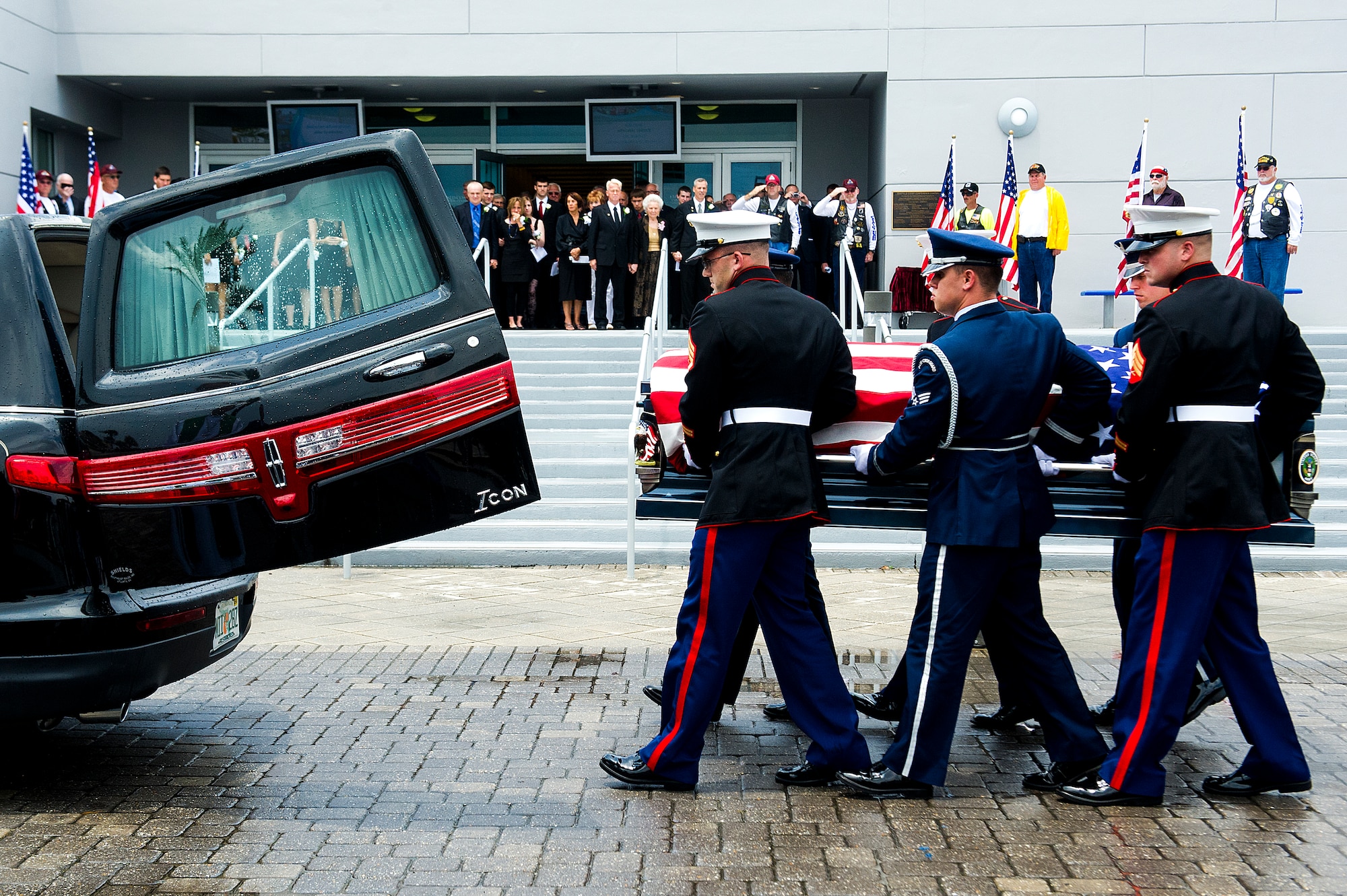 Pallbearers made up of Airmen and Marines carried the casket out during a memorial service for retired U.S. Air Force Col. George “Bud” Day at the Emerald Coast Convention Center on Okaloosa Island, Fla., Aug. 1. Day, a Medal of Honor recipient and combat pilot with service in World War II, Korea and Vietnam, passed away July 28 at the age of 88. (U.S. Air Force Photo / Airman 1st Class Christopher Callaway)