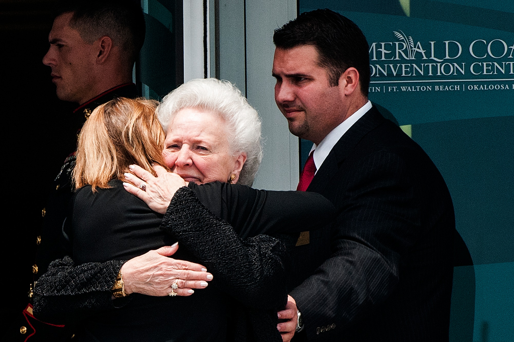 Doris Day, widow of Col. George “Bud” Day, received a hug during a memorial service for Day at the Emerald Coast Convention Center on Okaloosa Island, Fla., Aug. 1. Day, a Medal of Honor recipient and combat pilot with service in World War II, Korea and Vietnam, passed away July 28 at the age of 88. (U.S. Air Force Photo / Airman 1st Class Christopher Callaway)