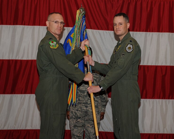 Col. Michael Adderley, 2nd Operations Group commander, passes the 20th Bomb Squadron guidon to Lt. Col. Scott Maytan, incoming 20th Bomb Squadron commander, during a change-of-command ceremony on Barksdale Air Force Base, La., Aug. 1, 2013. Maytan is a master navigator with more than 2,200 flight hours and has flown combat missions in operations Desert Fox, Allied Force and Iraqi Freedom. (U.S. Air Force photo/Senior Airman Benjamin Gonsier)