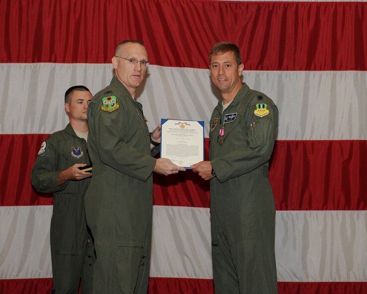 Col. Michael Adderley, 2nd Operations Group commander, presents the Meritorious Service Medal to Lt. Col. Eric Sikes, outgoing 20th Bomb Squadron commander, during a change-of-command ceremony on Barksdale Air Force Base, La., Aug. 1, 2013. Sikes served as the 20th BS commander from April 2012 to Aug. 2013. He is a command pilot with more than 2,900 flight hours and ensured more than 80 aircrew personnel maintained combat readiness during his time in command. (U.S. Air Force photo/Senior Airman Benjamin Gonsier)