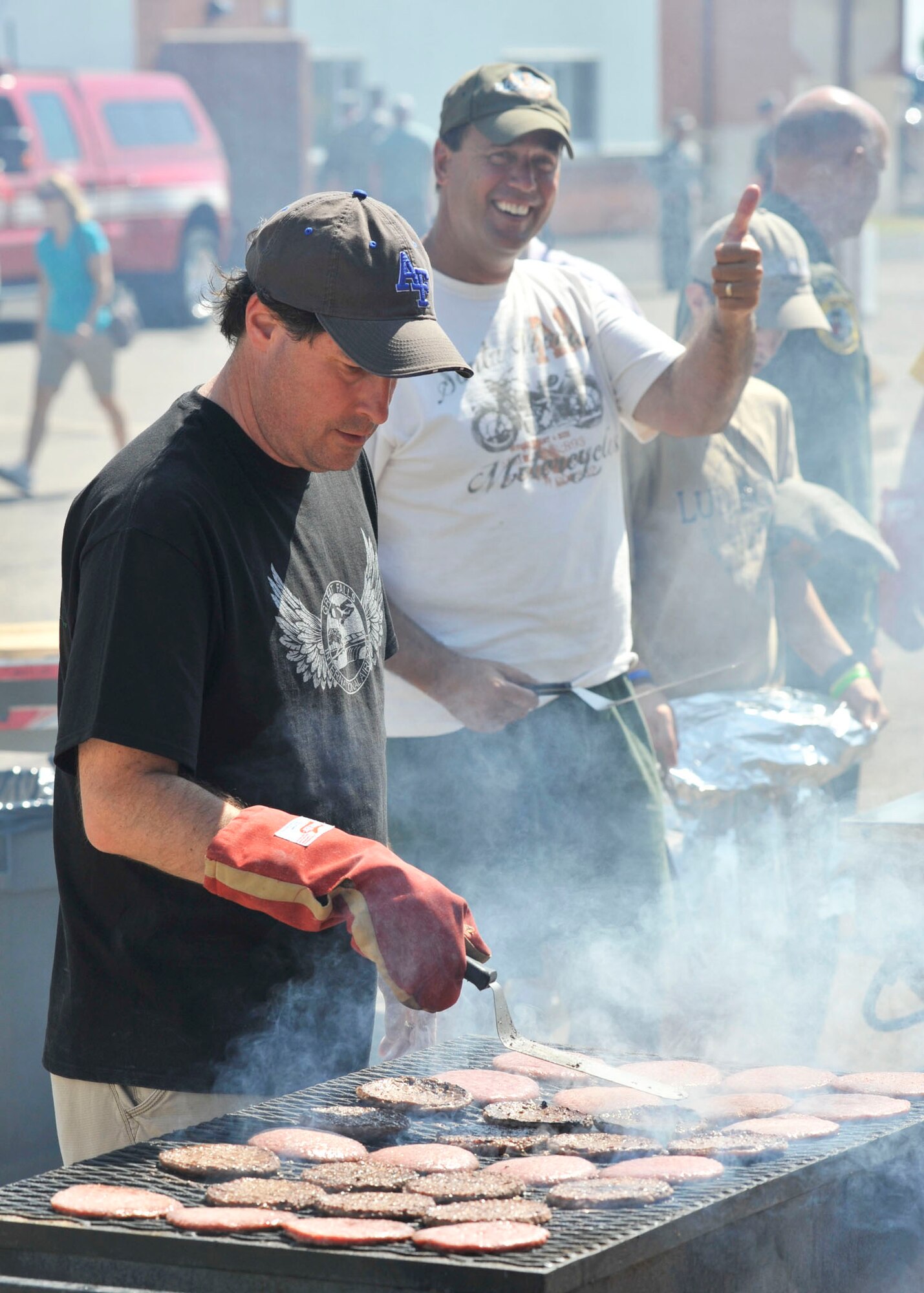 Members of the Great Falls Area Chamber of Commerce Military Affairs Committee cook the food served during the Montana Air National Guard Family Day picnic on Aug. 11, 2012. (U.S. Air Force photo/John Turner)
