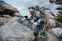 Kirk Clark, 341st Medical Operations Squadron exercise physiologist, walks in the backwoods of Montana during a hunt. The antlers he carries with him are used to lure game in close during a hunt. (Courtesy photo)