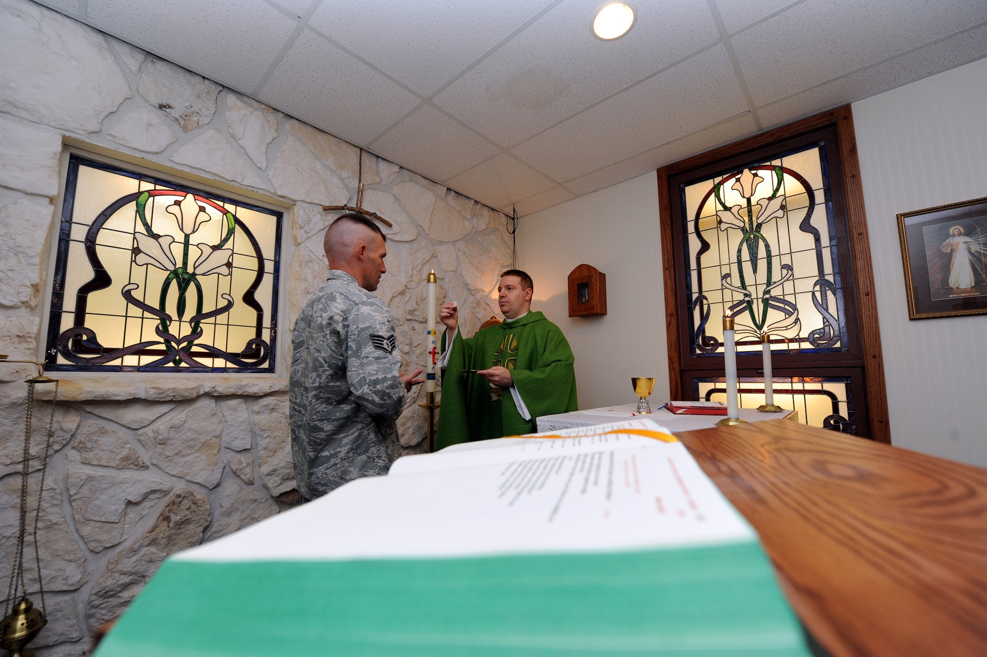 Staff Sgt. William Curtiss, 341 Missile Wing chaplain’s assistant, receives a communion wafer from Chaplain (Capt.) Matthew Glaros. Catholic services are held daily at 11:15 a.m., on Saturdays at 5 p.m. and Sundays at 9 a.m. Reconciliation is held Saturdays at 4 p.m. and Sunday through Friday by appointment only. Protestant services are held Sundays at 11:15 a.m. (U.S. Air Force photo/Staff Sgt. R.J. Biermann)